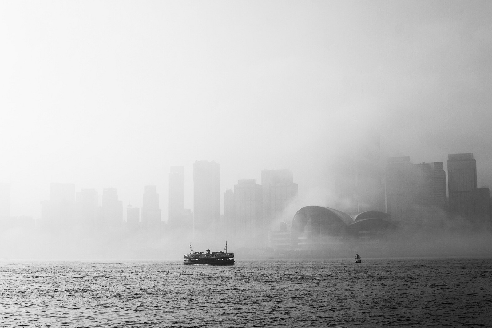 A solitary Star Ferry cruises mid-harbour in the morning fog of Spring.