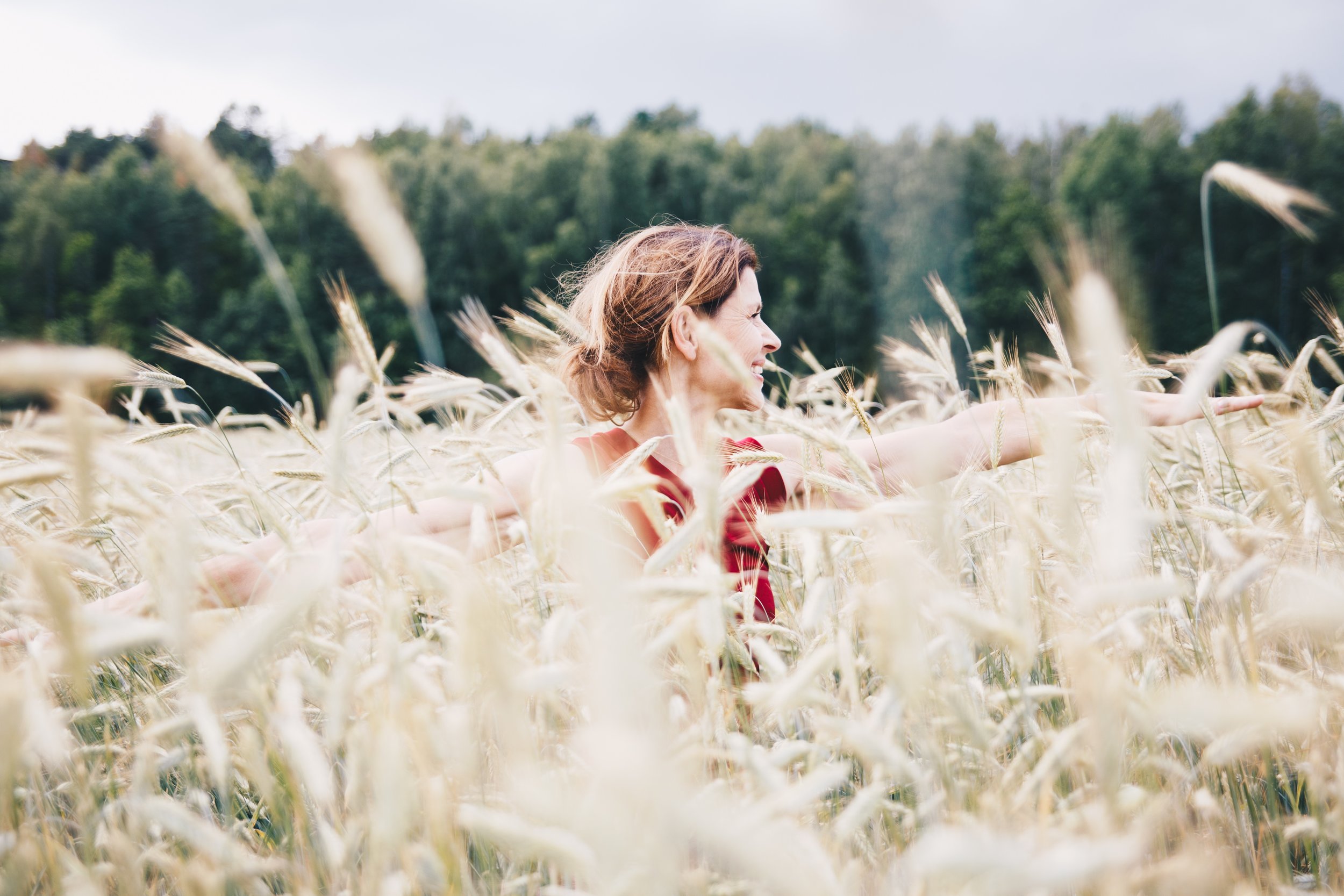 Woman doing yoga in field of wheat