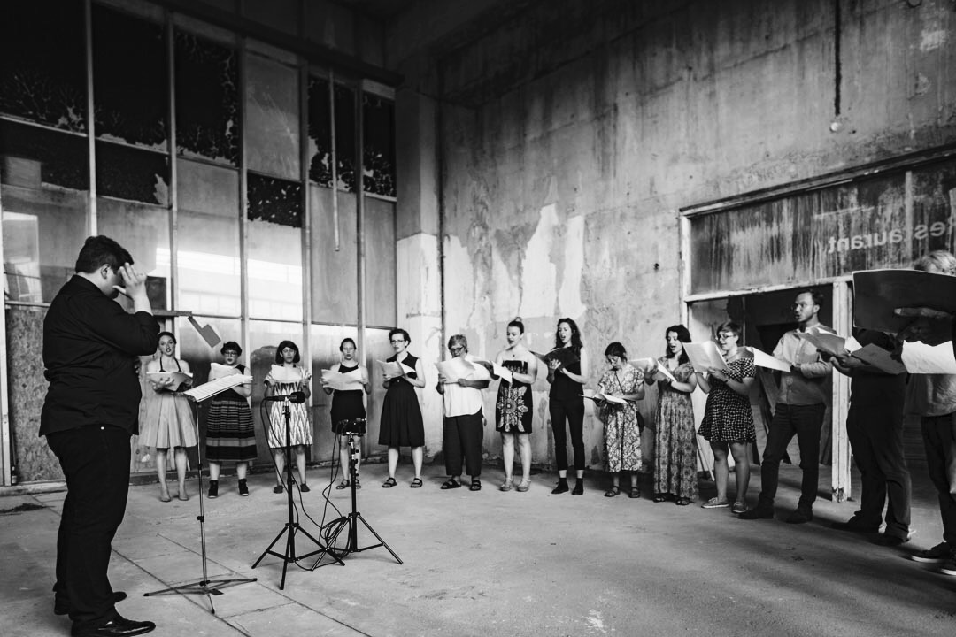Guest conducting London Metropolitan University's Musarc Choir in Benjamin Tassie 's 'Silvertown' at the old Carlsberg & Tetley's Factory in Silvertown , London (UK); June 2017