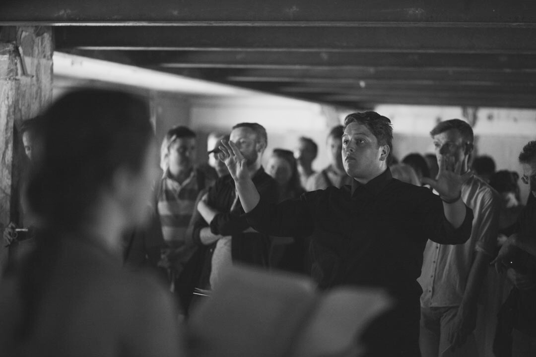Guest conducting London Metropolitan University's Musarc Choir in Benjamin Tassie 's 'Silvertown' at the old Carlsberg & Tetley's Factory in Silvertown , London (UK); June 2017