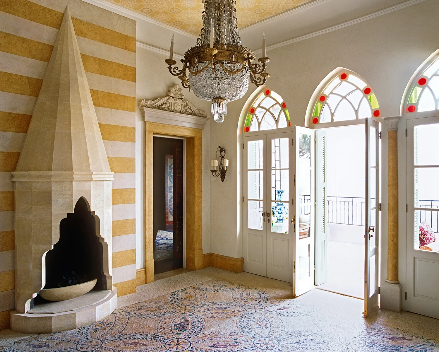 This is a genuine hybrid design because there is that effortless mix of so many references, from the Roman style mosaic to the Ottoman style carved marble fireplace, with an example of local plasterwork above the doorway. 