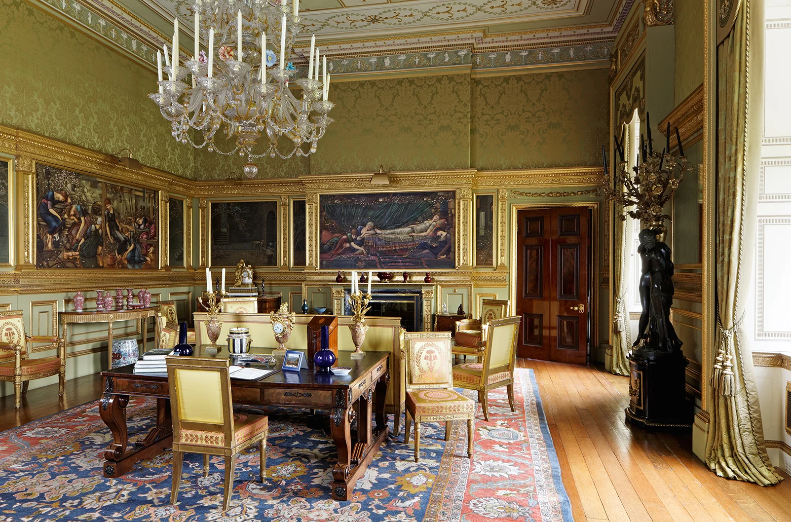 The restoration of The Saloon at Buscot Park gave me the opportunity to repair and revitalise a magnificent eighteenth century room. The room contains a series of Edward Burne-Jones, who also designed the paneling in which the paintings are framed. What you now see is a restored and recoloured room : to set off the gilfing on the paneling I used a particularly chartreuse-green tone and had a green silk damask specially woven for the walls. The picture lights were copied from one that had been previously installed but each of the new ones conceals the latest lighting technology to illuminate these magnificent paintings that tell the story of Briar Rose.