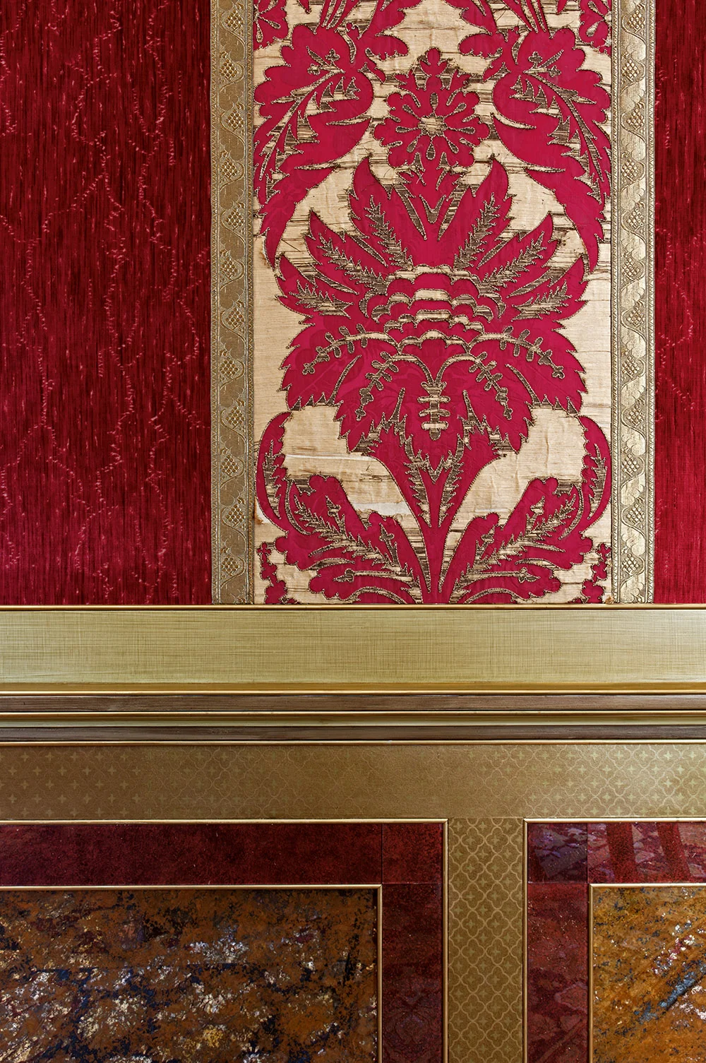 Verre eglomise and hand printed paper panels that imitate fabric sit above the decorated dado rail. 