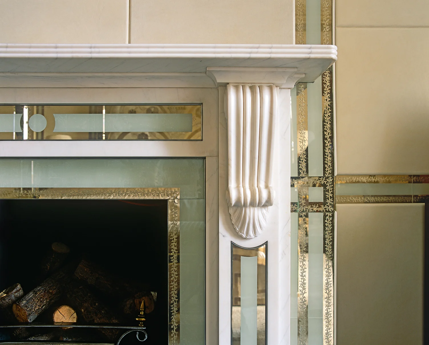 The master bedroom walls in this London home have a unique quality - each section has been upholstered in soft, off-white kid leather, which is surrounded by a narrow glass slip that has been edged with a decorative gilded coral pattern. 