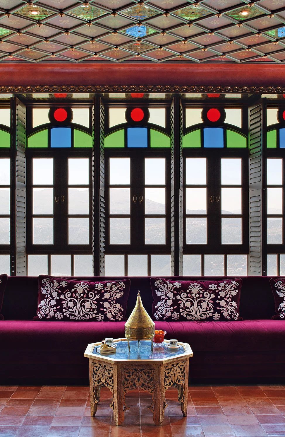 I designed these coloured-glass windows, having taken inspiration from historic Lebanese architecture, and the fine wool boucle embroidered cushions are among the many details that further enhance the space. Its charming, informal character is inviting, coaxing you to just sit and be.
