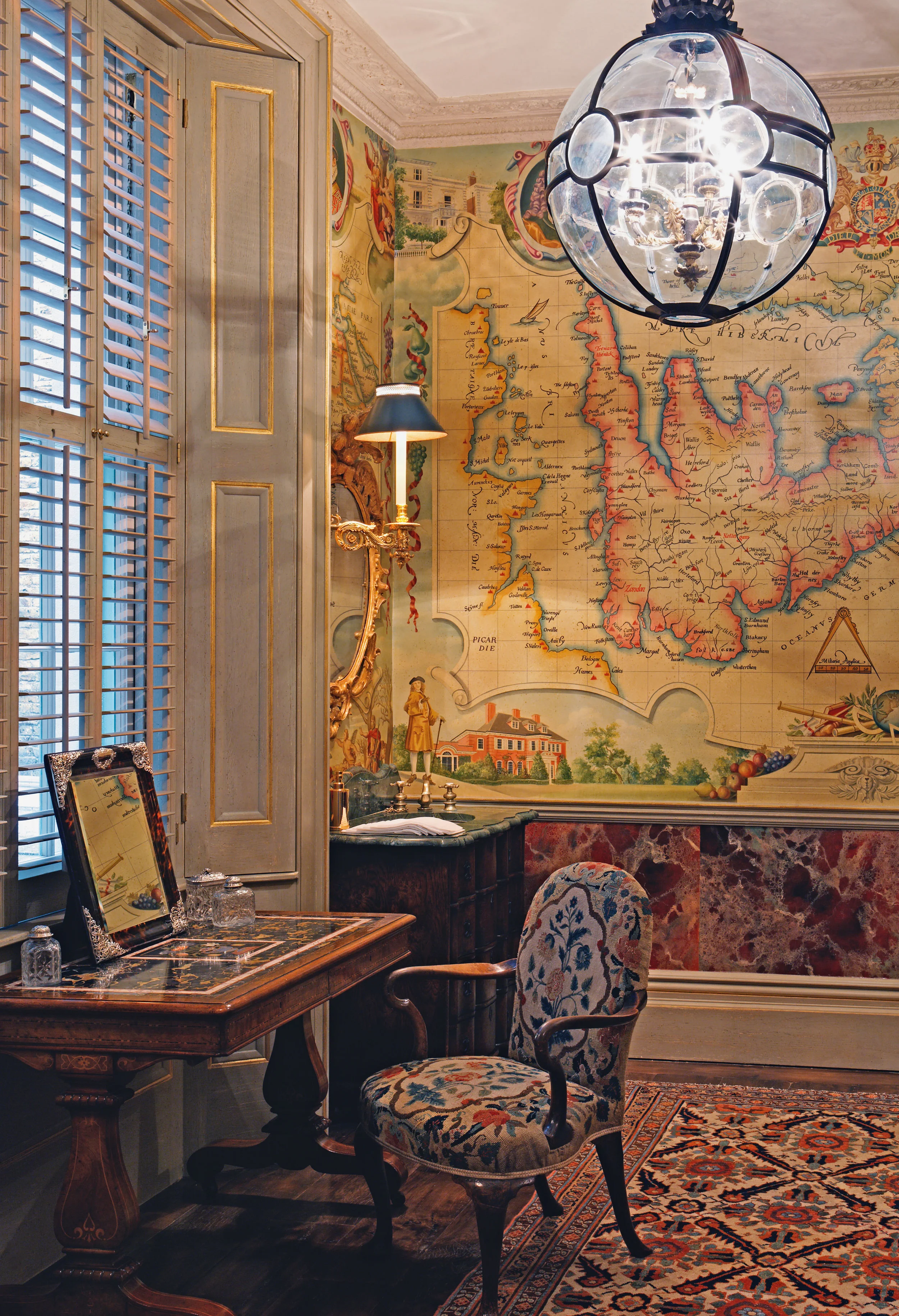 This London cloakroom feels like a properly appointed room in which you would happily spend time. The walls are clad in a painted world-map canvas featuring Britain as it was depicted in the seventeenth-century - to this I have added almost imperceptible red dots, pinpointing favourite places of the client.