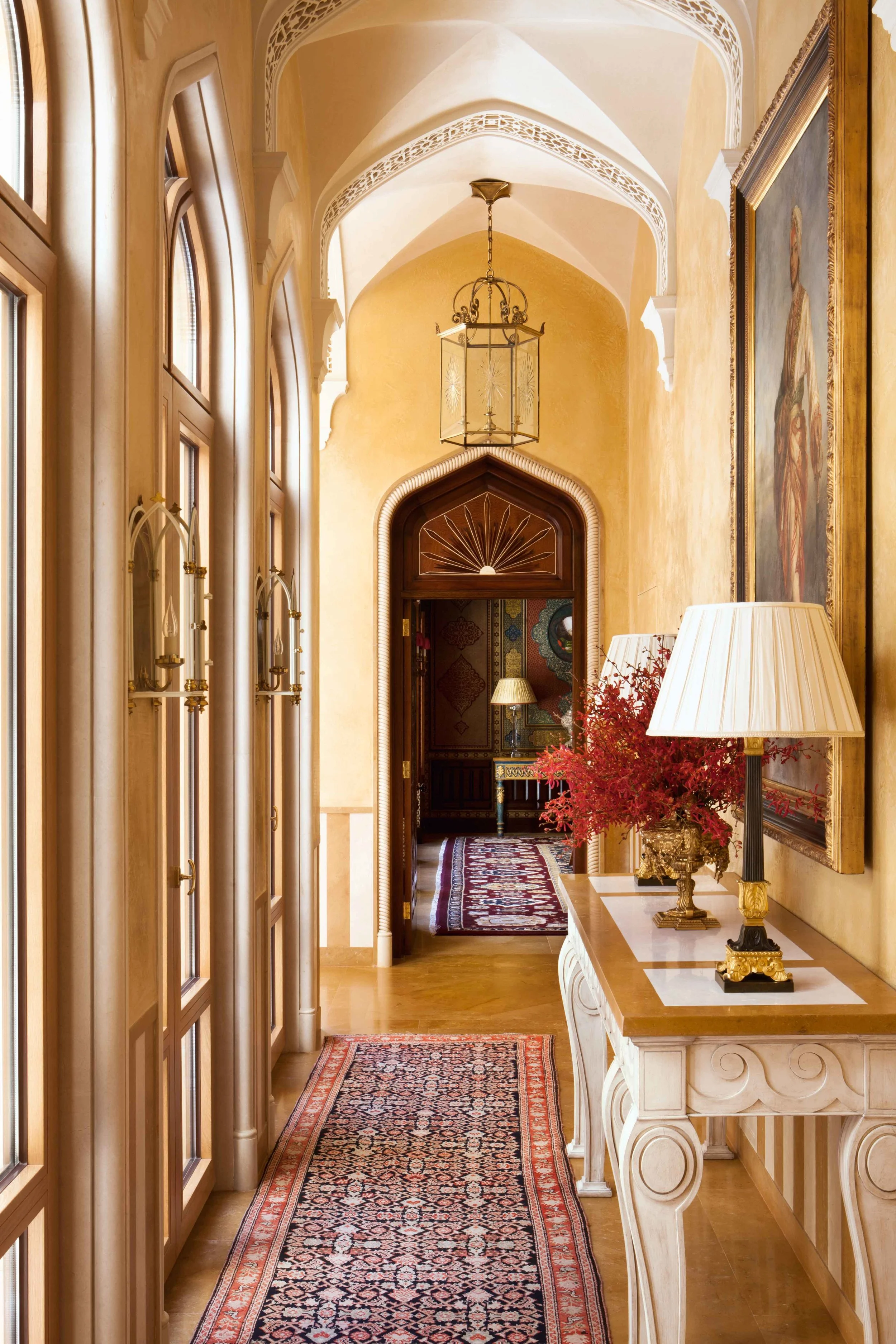 This hallway draws you to exciting and enticing views from whichever way you look as it also faces outward toward a central courtyard. I devised this series of arches with Islamic inspired grillwork and arched doorways with carved stone rope surrounds to make the most of the majestic height of the building. Hanging overscaled gilt lanterns lot into the space also added to the filling-in of the height and helped proportion the whole space gracefully.