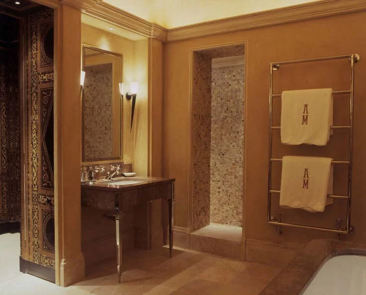 The view from the bathroom looking out towards that dressing room and the shower room; monogrammed towels hang for that tailor-made finish.