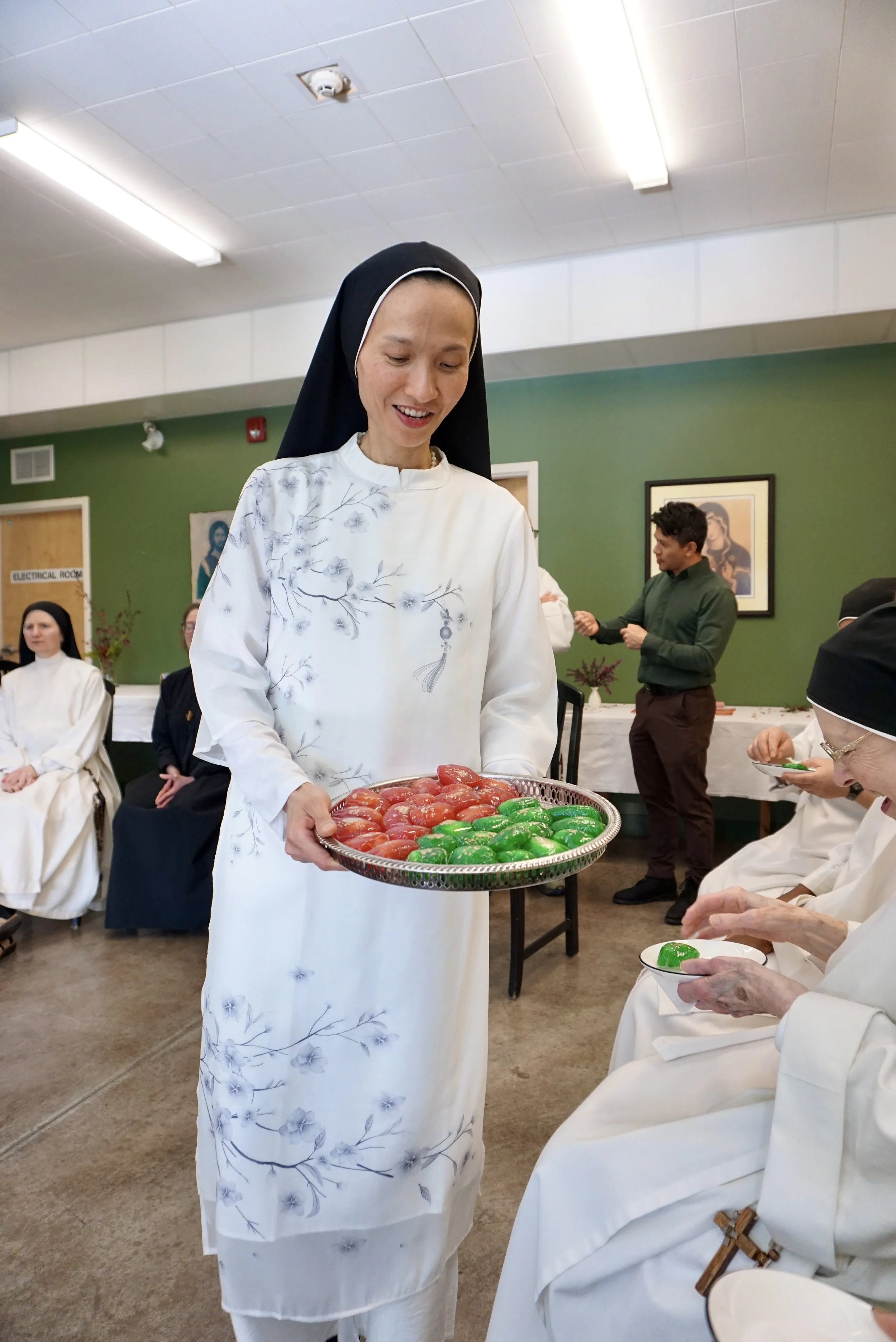 Sharing Bánh Phu Thê with community and guests.