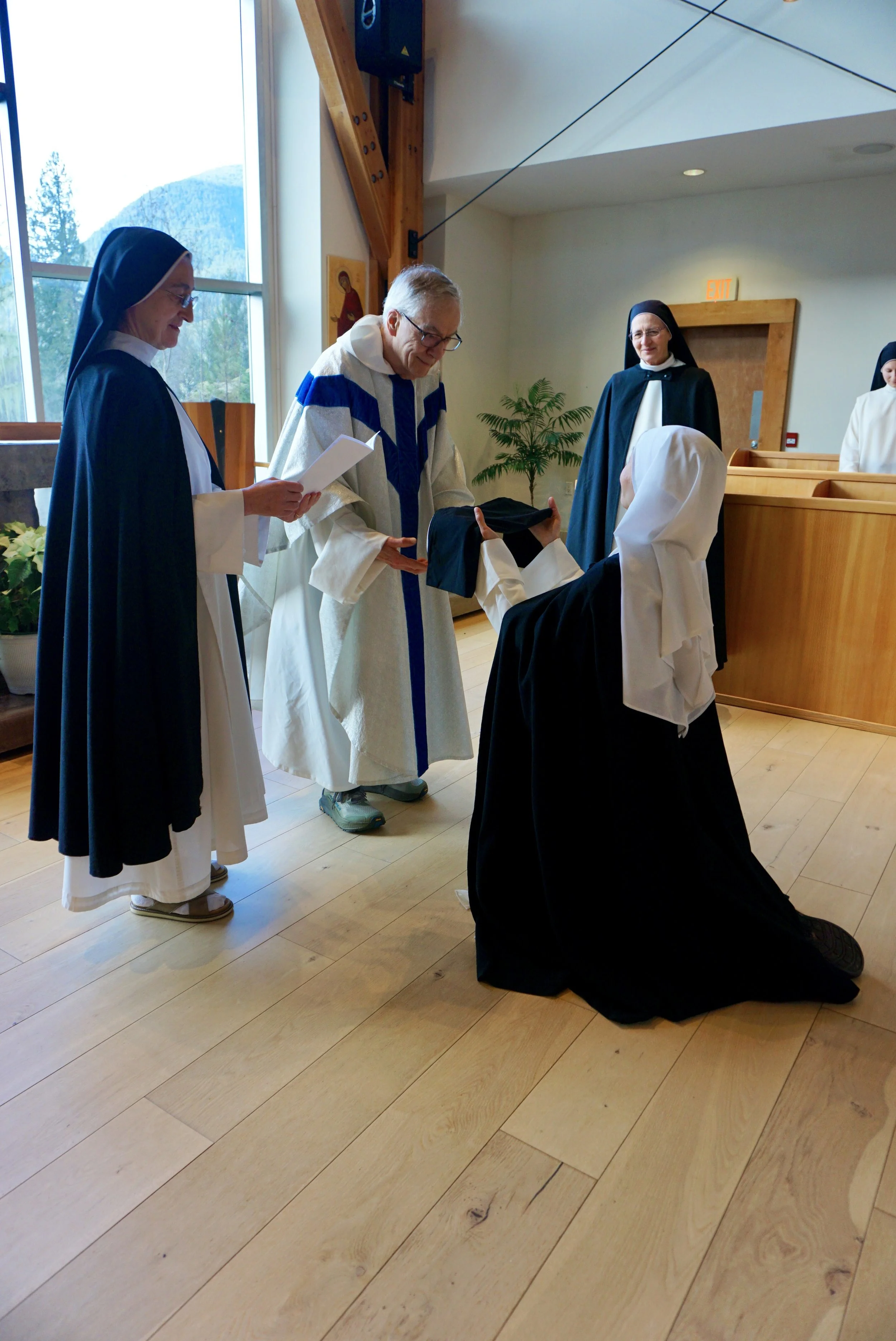 Receiving the black veil of a professed nun.