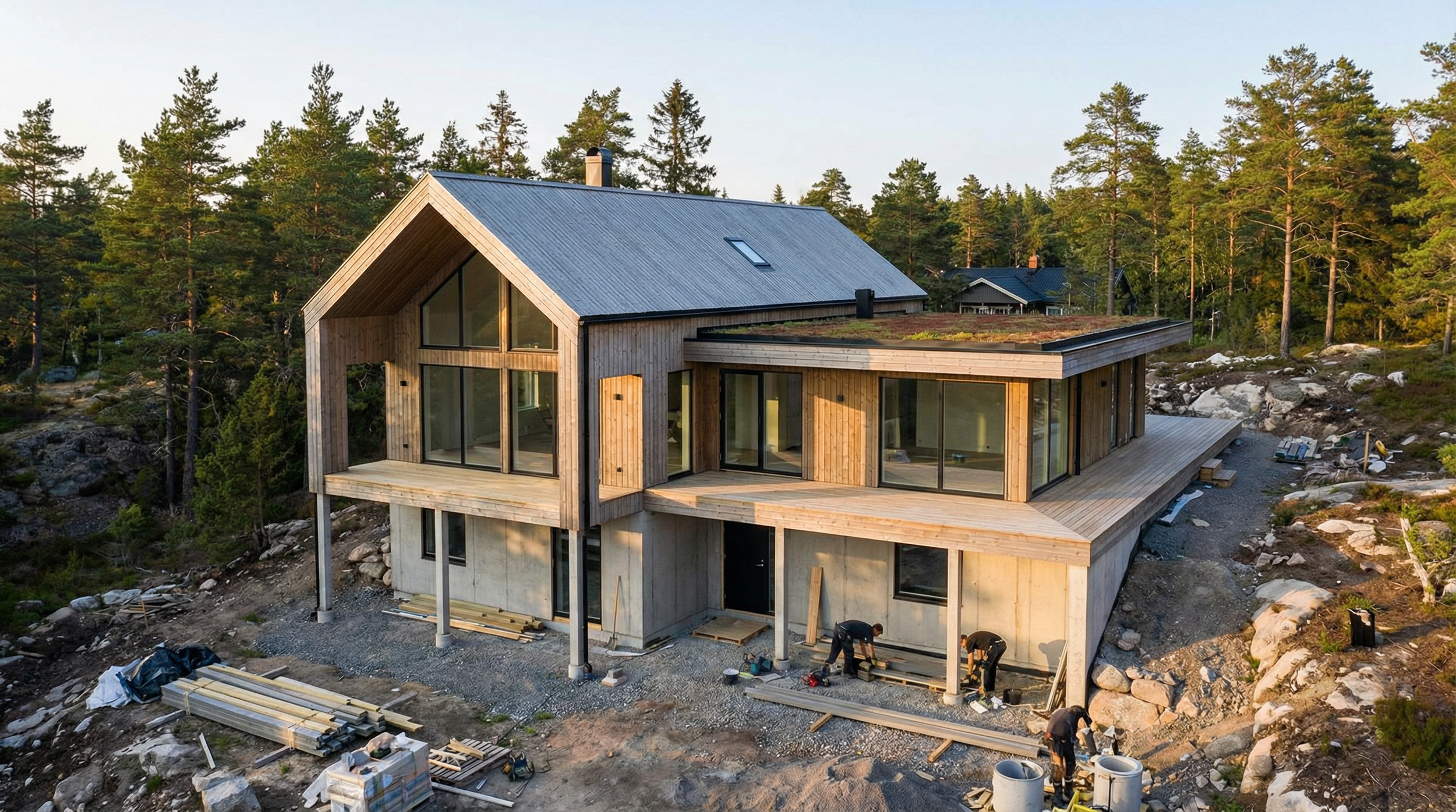 Bright open-concept living room and kitchen with white walls, wooden flooring, modern furniture, and large windows allowing natural light.