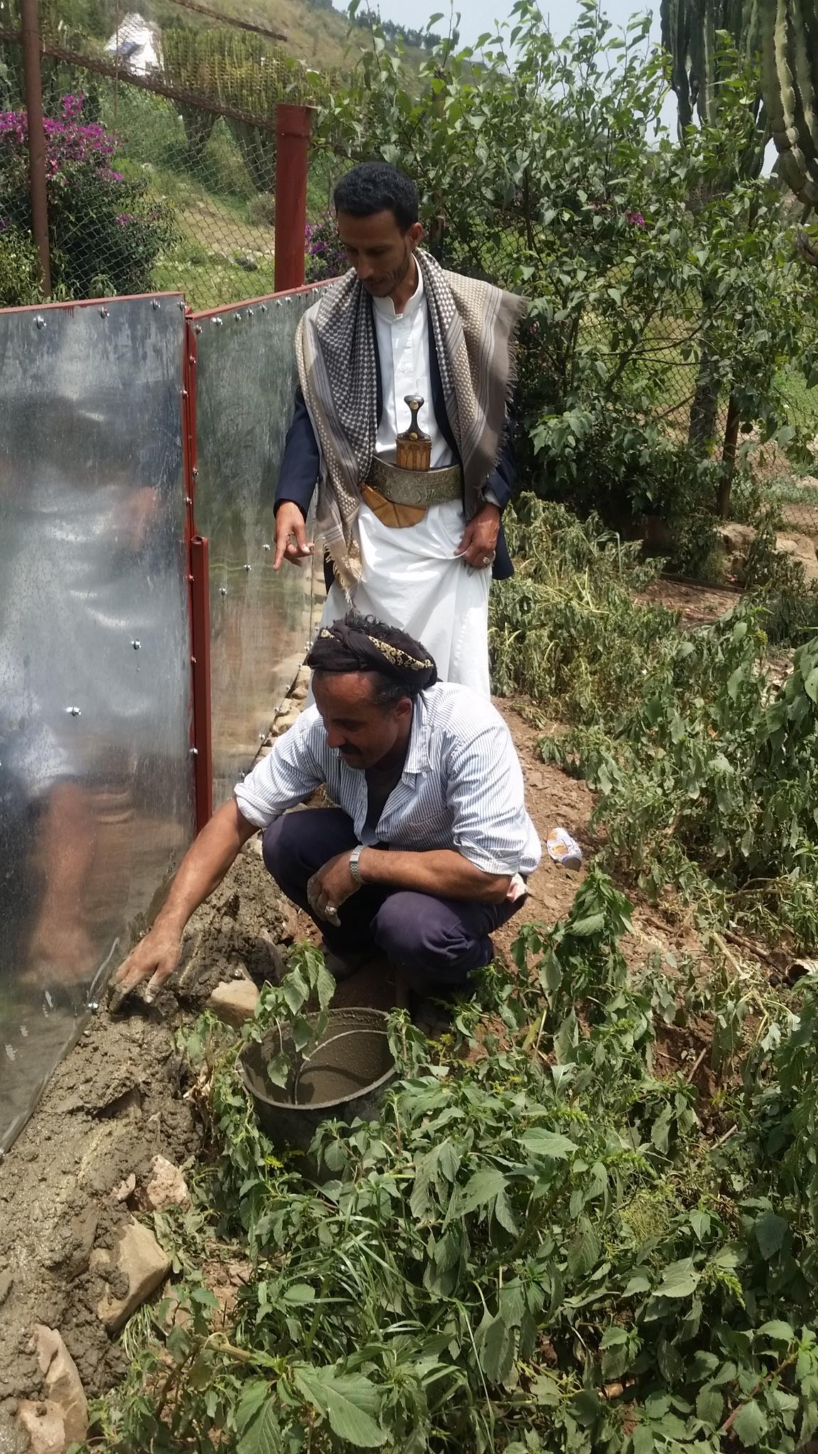 Ibb Zoo Rescue Omar with worker on hyena separation fence 28 July 2017.jpg