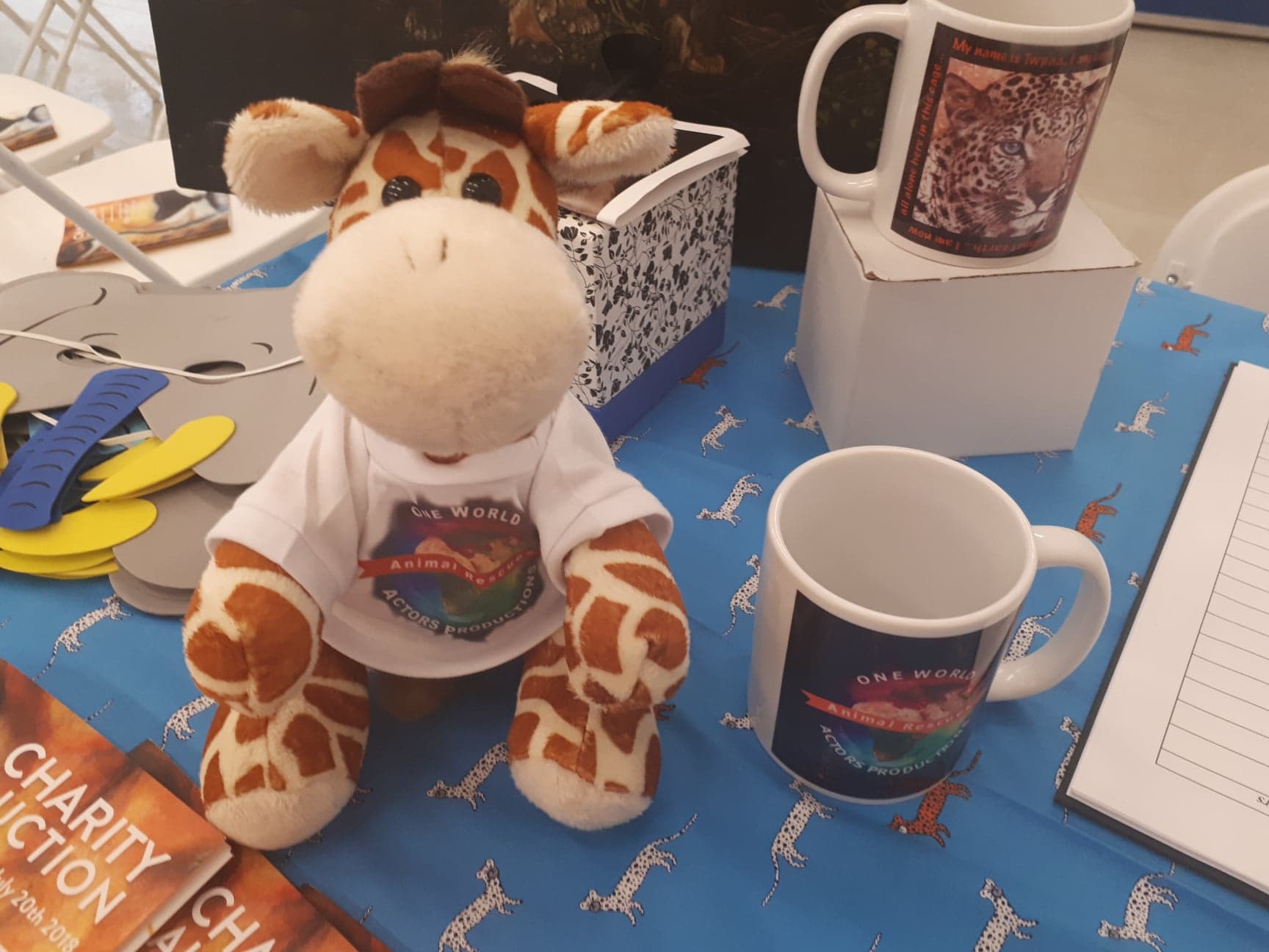 owapar merch  viggo the giraffe mugs T shirts TERA fabric 20 JULY 2018 our charity event welcome desk 1.jpg