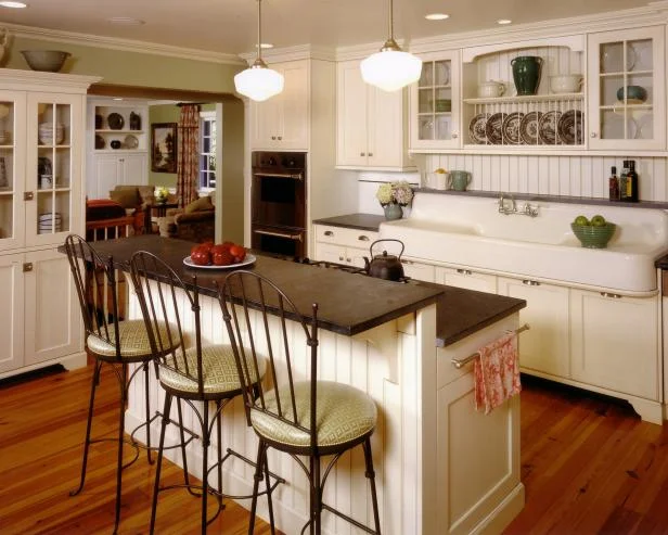 Bar height stools at the bi-level counter in this country kitchen via HGTV.com