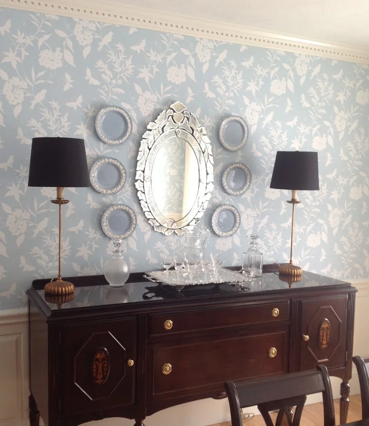 A pair of tall skinny buffet lamps in a classic dining room