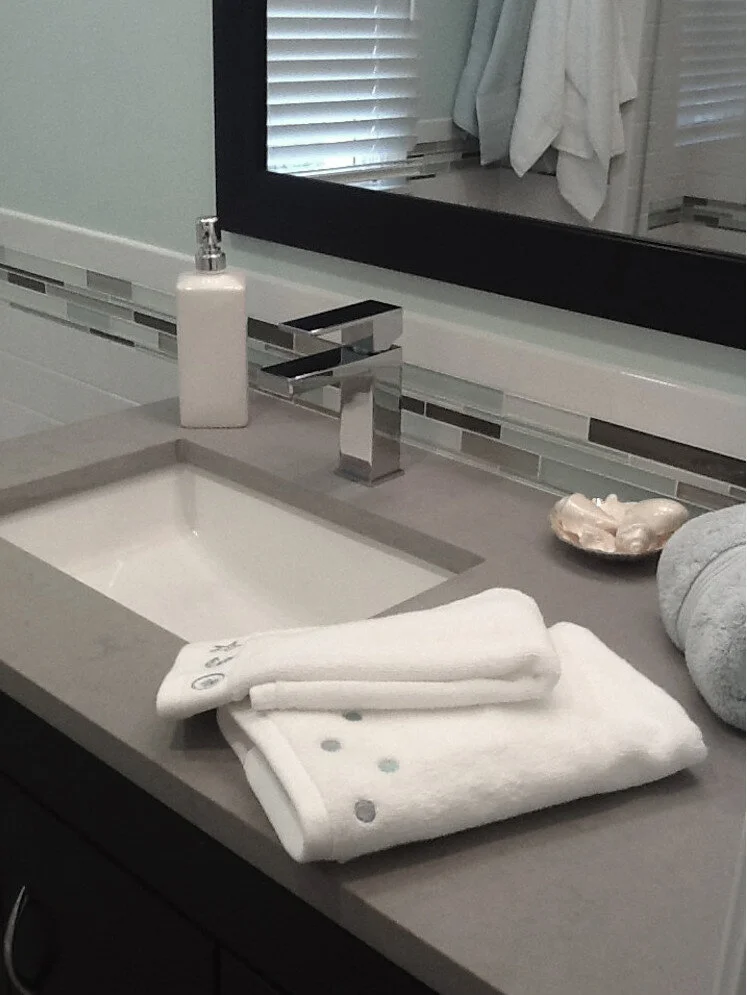 Slate gray Caesarstone quartz counters in this bathroom renovation we did several years ago.