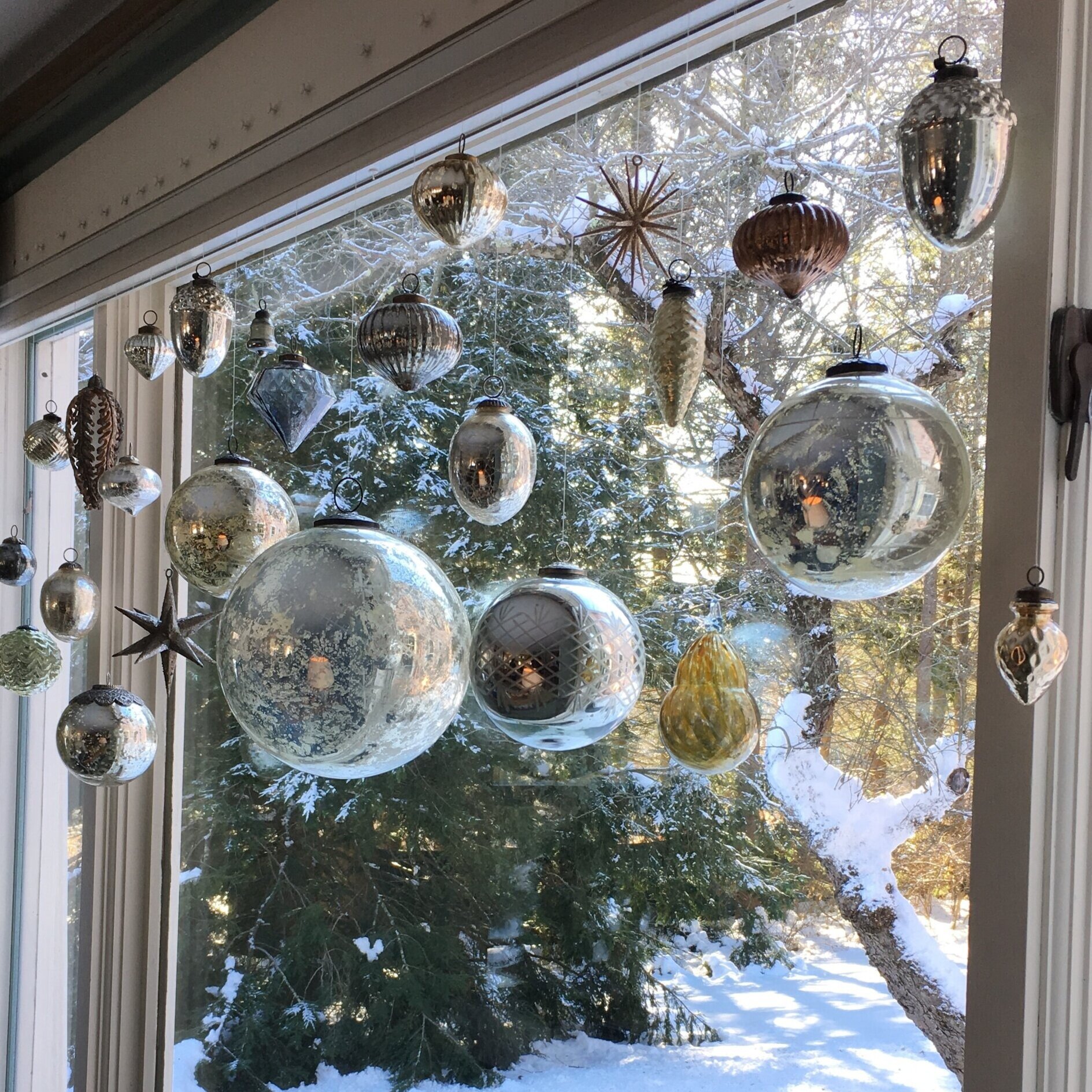 Blown+and+mercury+glass+ornaments+decorate+a+picture+window.jpg