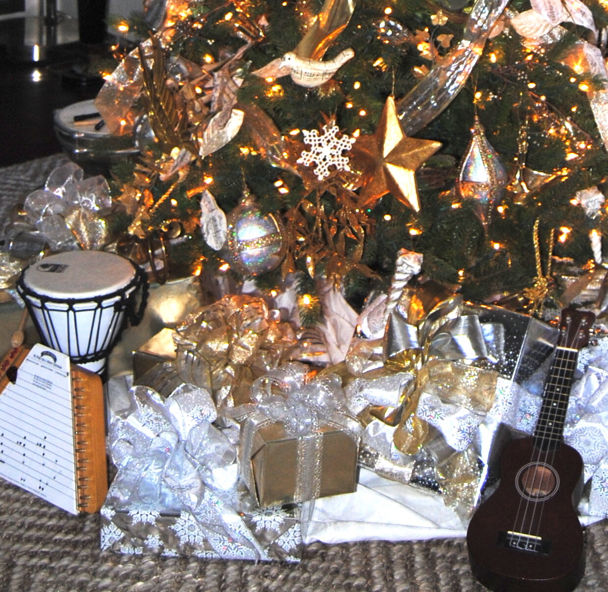 musical instruments and gold and silver packages beneath the tree.jpg