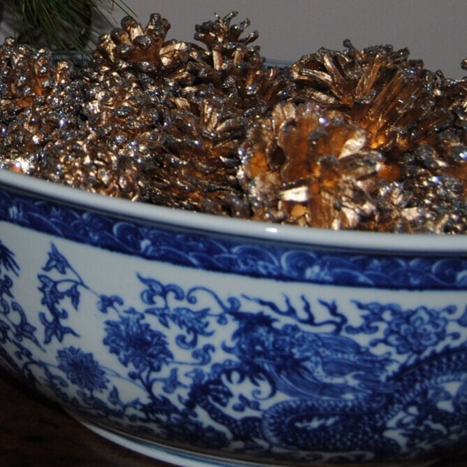 Gilded+pine+cones+in+a+blue+bowl.jpg