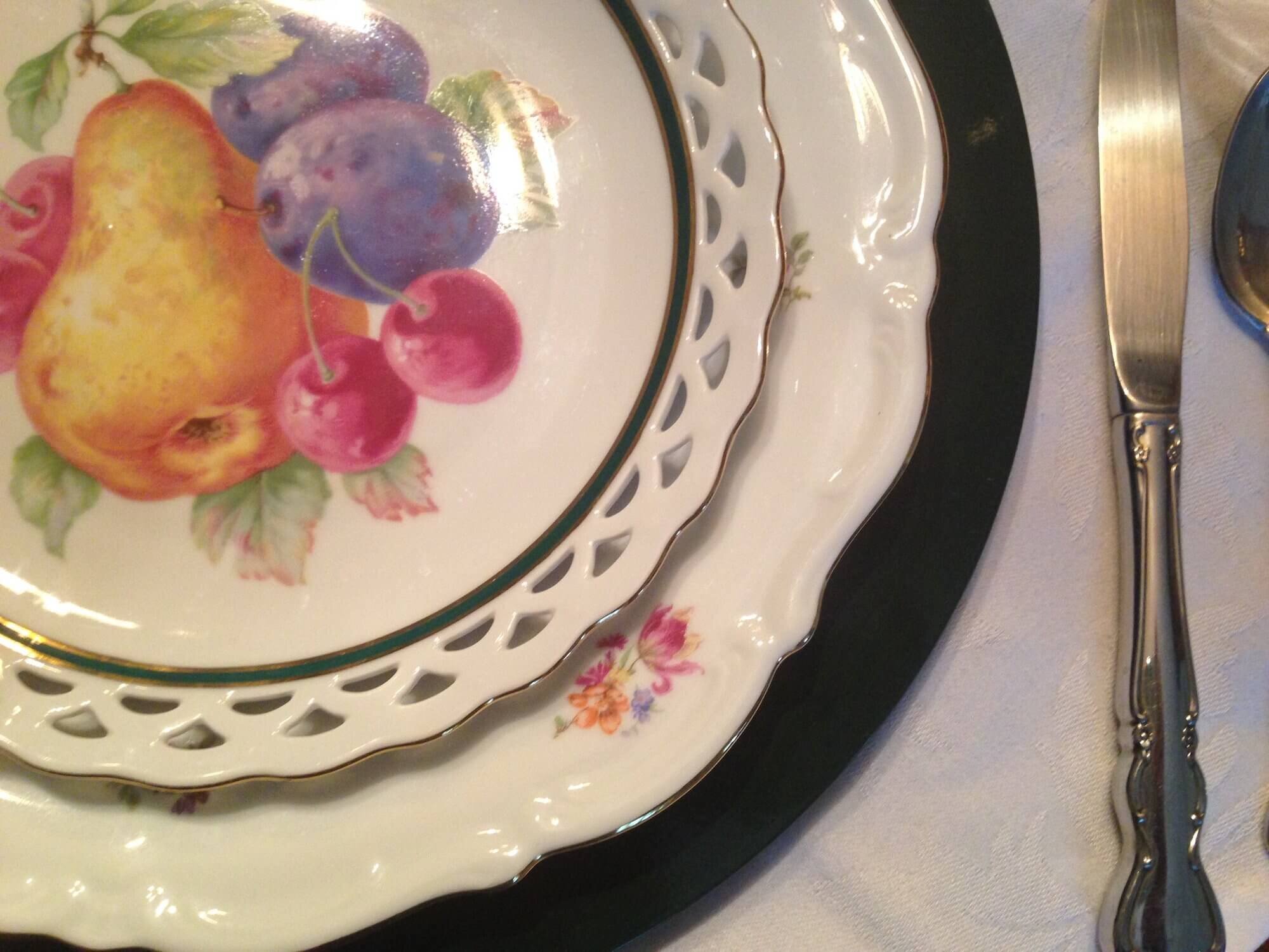 Pierced+antique+fruit+plates+top+vintage+china+dinner+plates,+along+with+basic+table+linens,+flatware,+and+glassware+to+add+a+splash+of+color+and+pattern+to+the+table.jpg