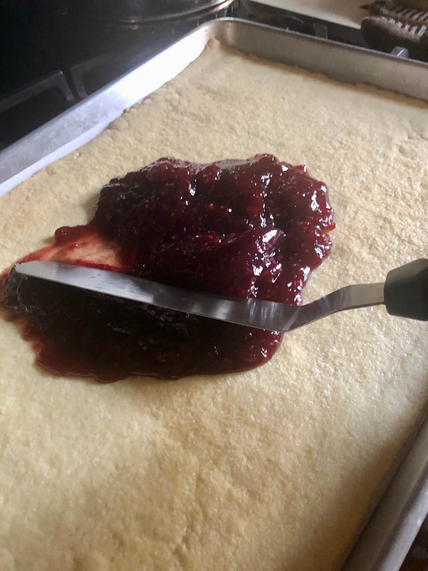 spread jam on baked crust