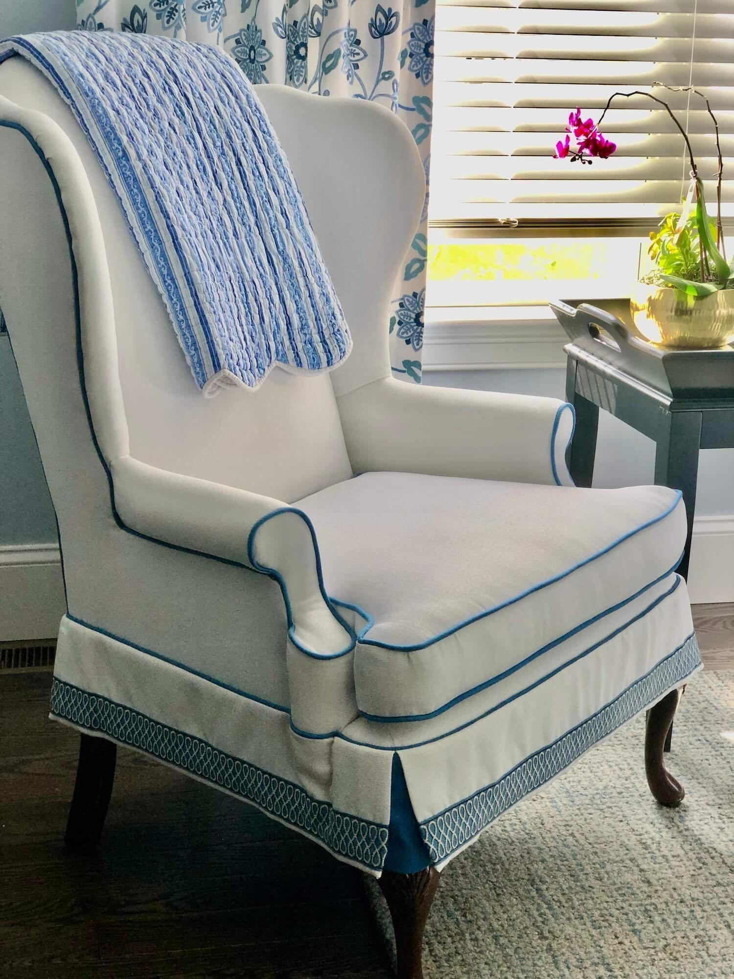 reupholstered wing chair with contrast welt and tape trim