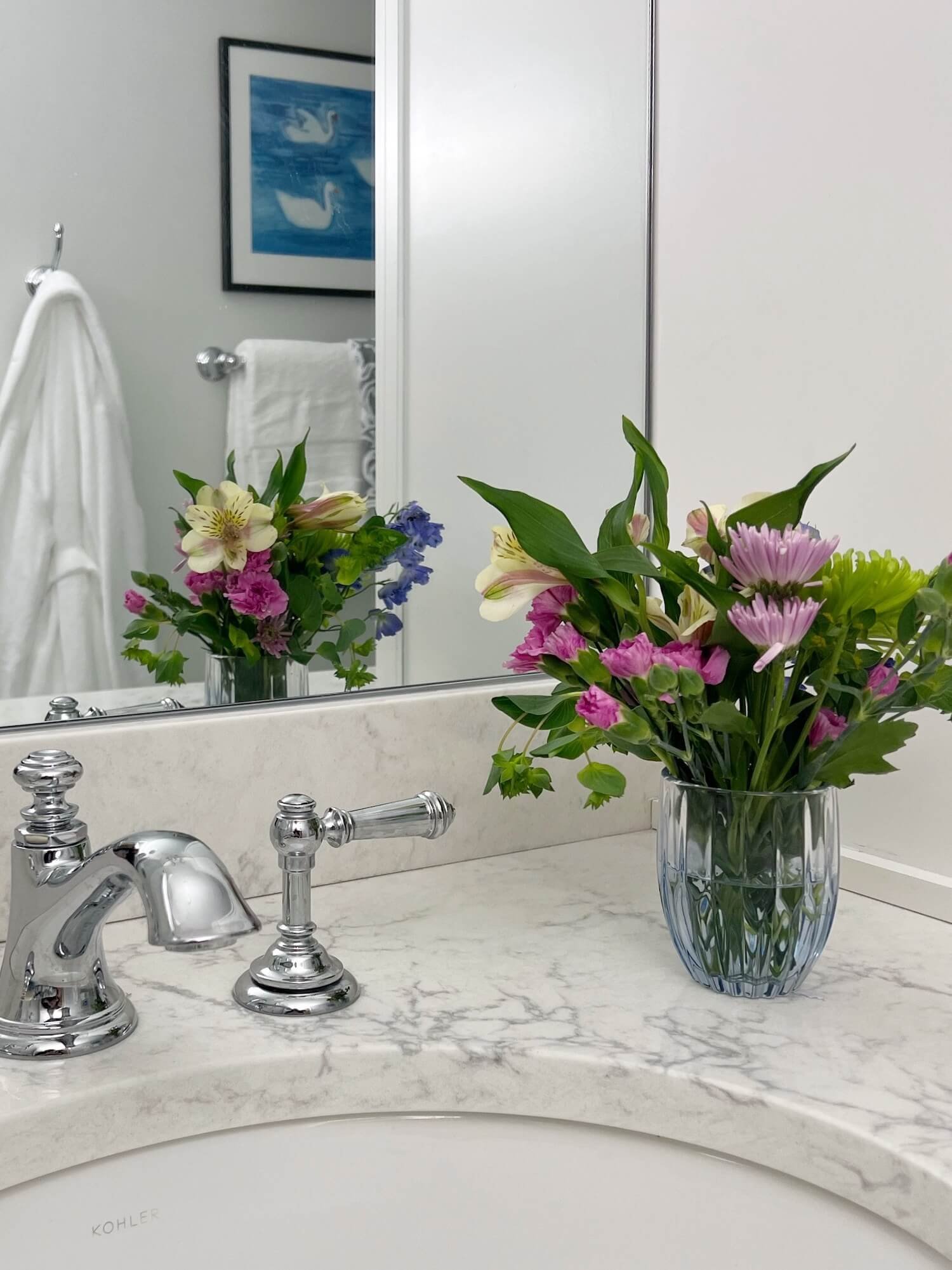 blue glass accessories in a white bathroom