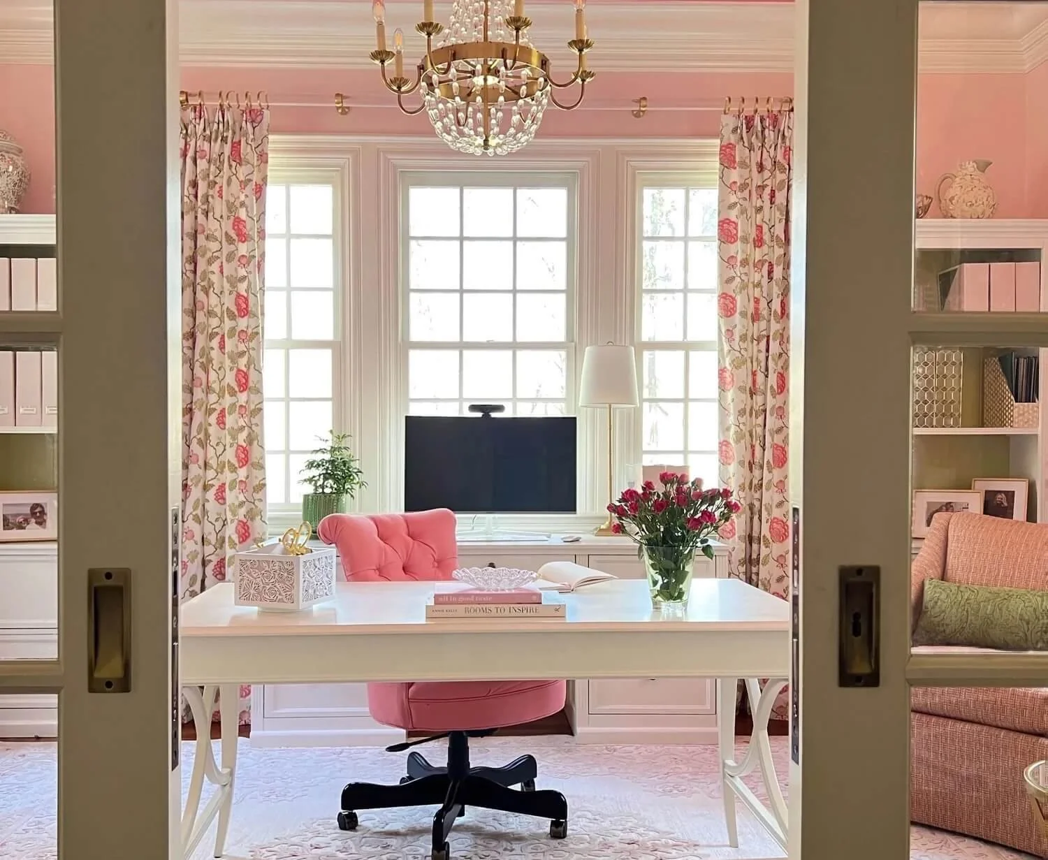 pink home office with vase of roses