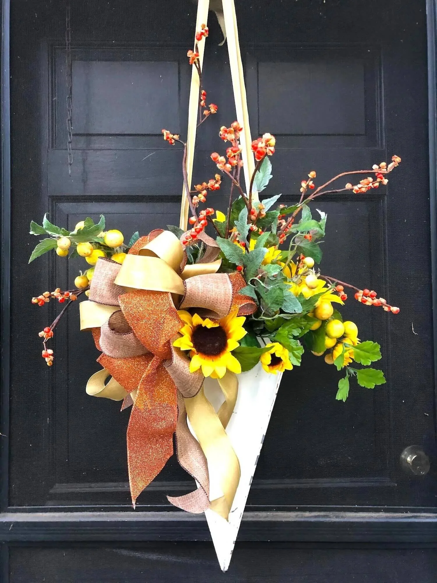 conical metal door basket with fall flowers and branches