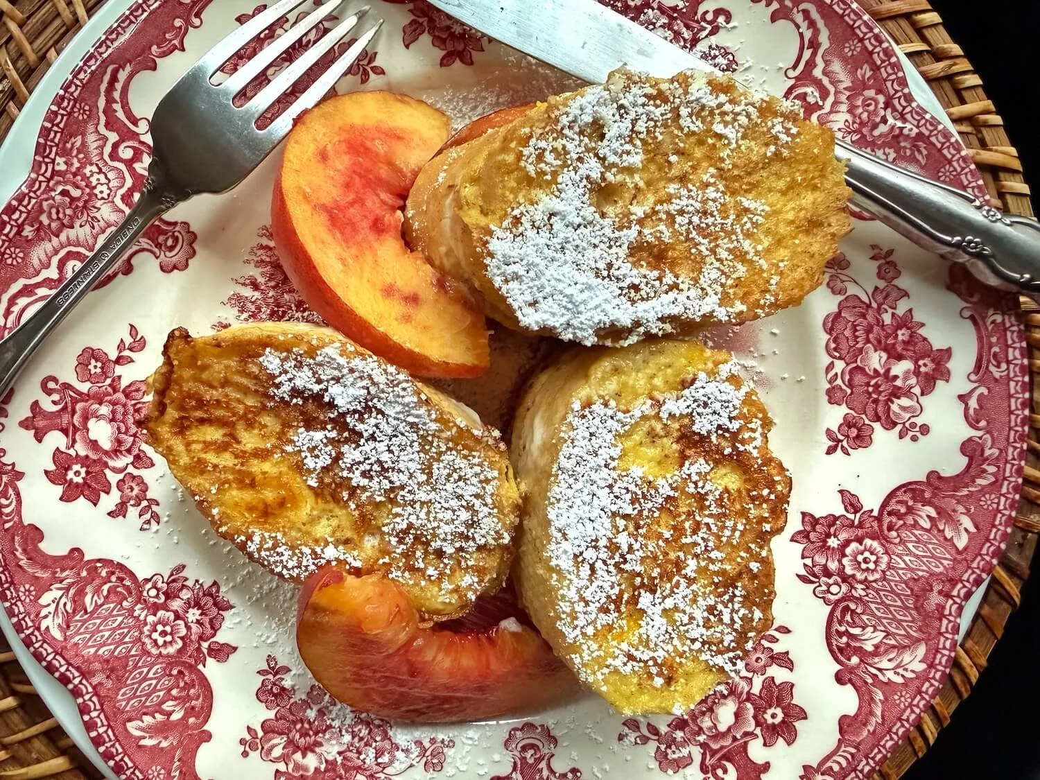 peach stuffed french toast with powdered sugar.