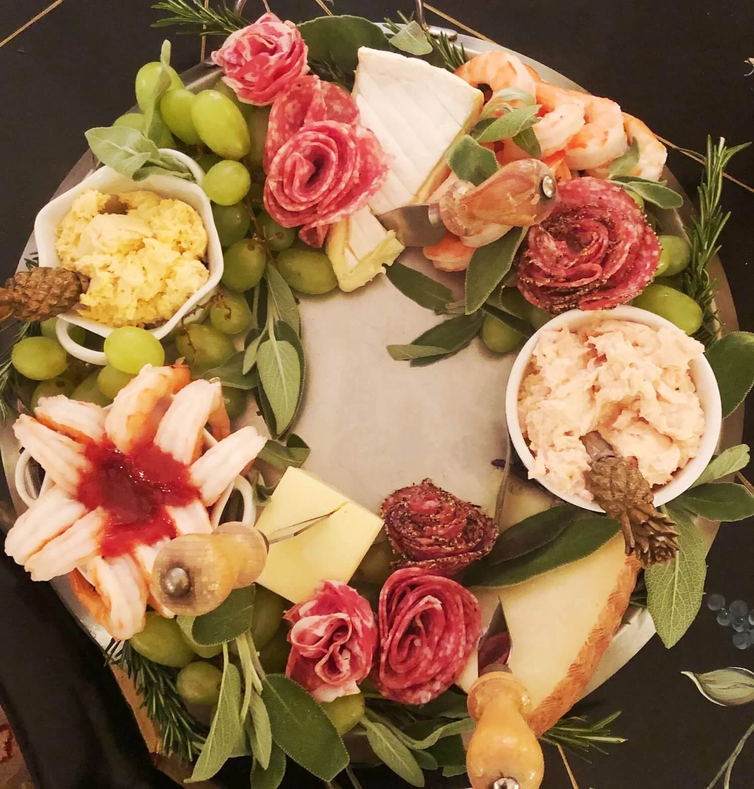 charcuterie wreath with shrimp cocktail on a round platter