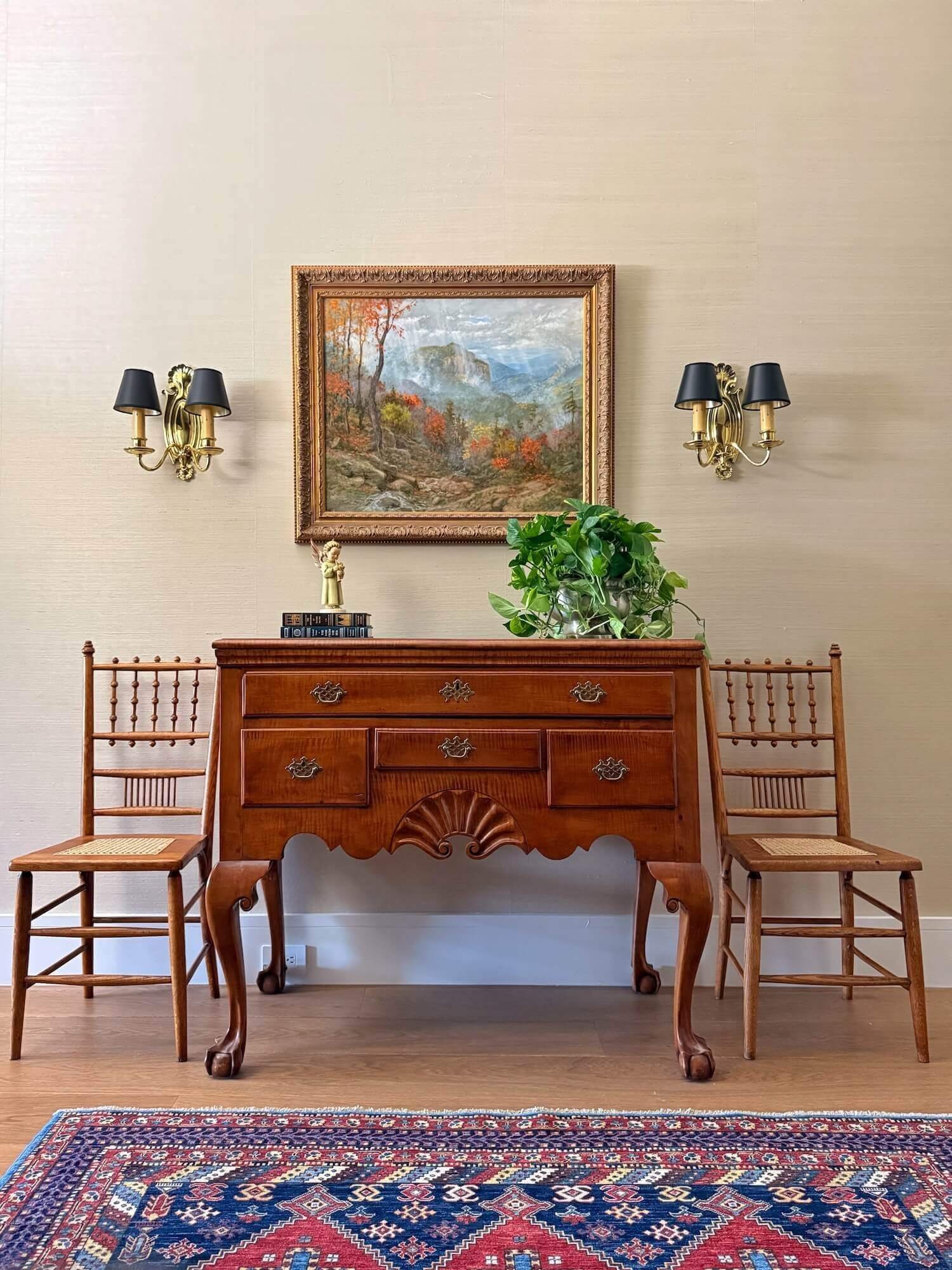 antique chest, chairs, and sconces in a Boston brownstone foyer