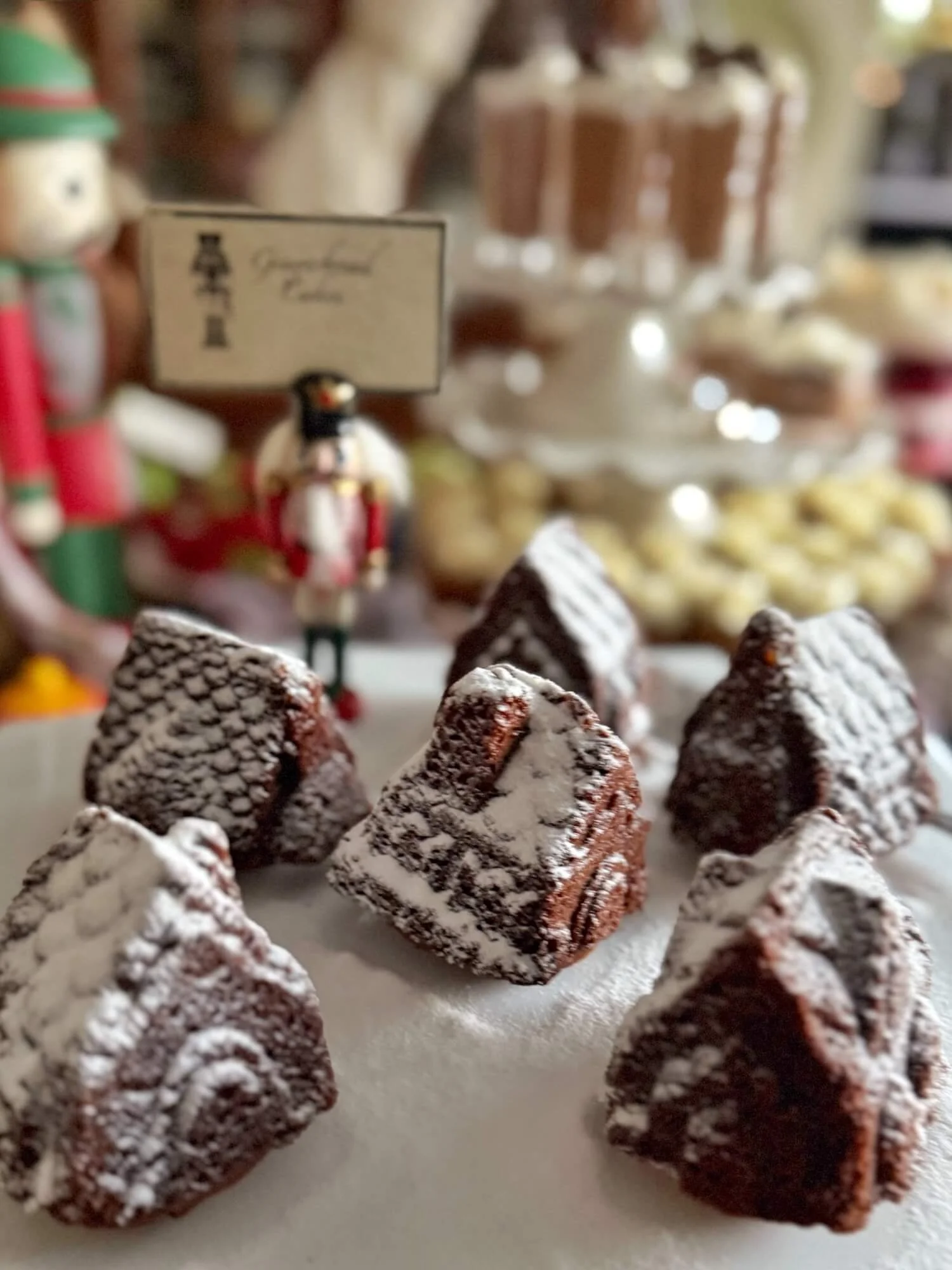 gingerbread village shaped cupcakes dusted with powdered sugar snow