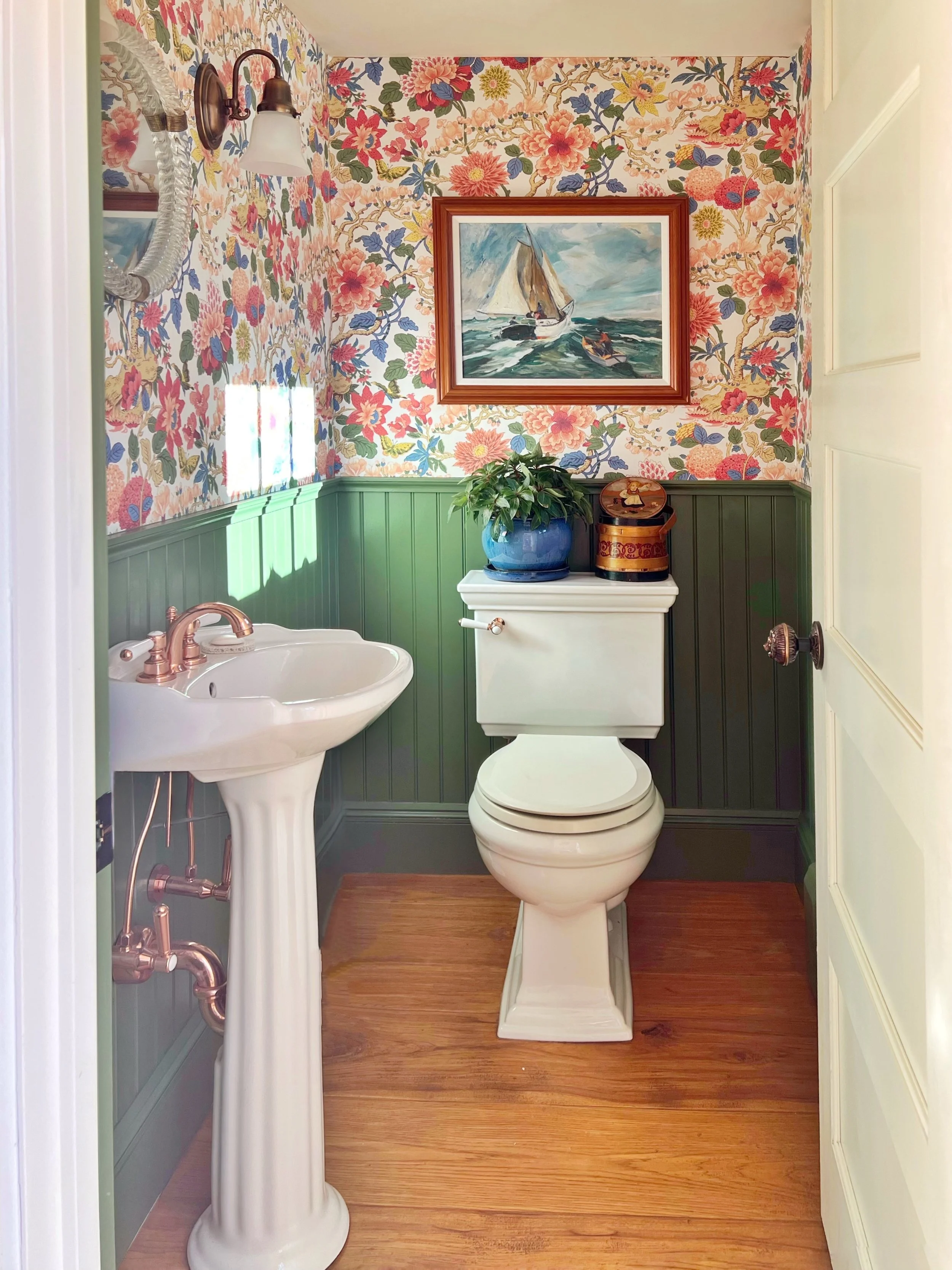 powder bath with coral and green wallpaper and paint