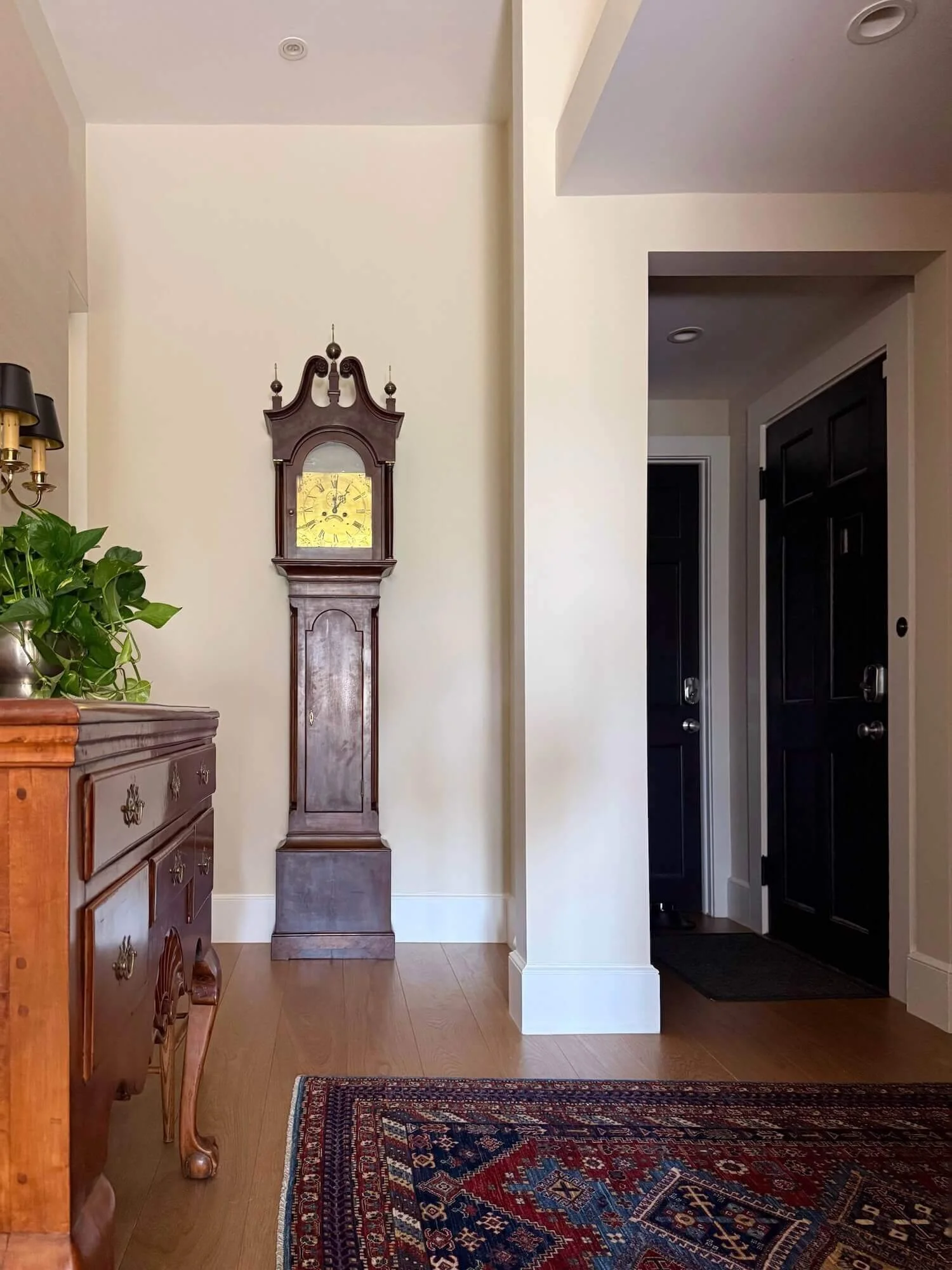 grandfather clock and antiques enliven a foyer