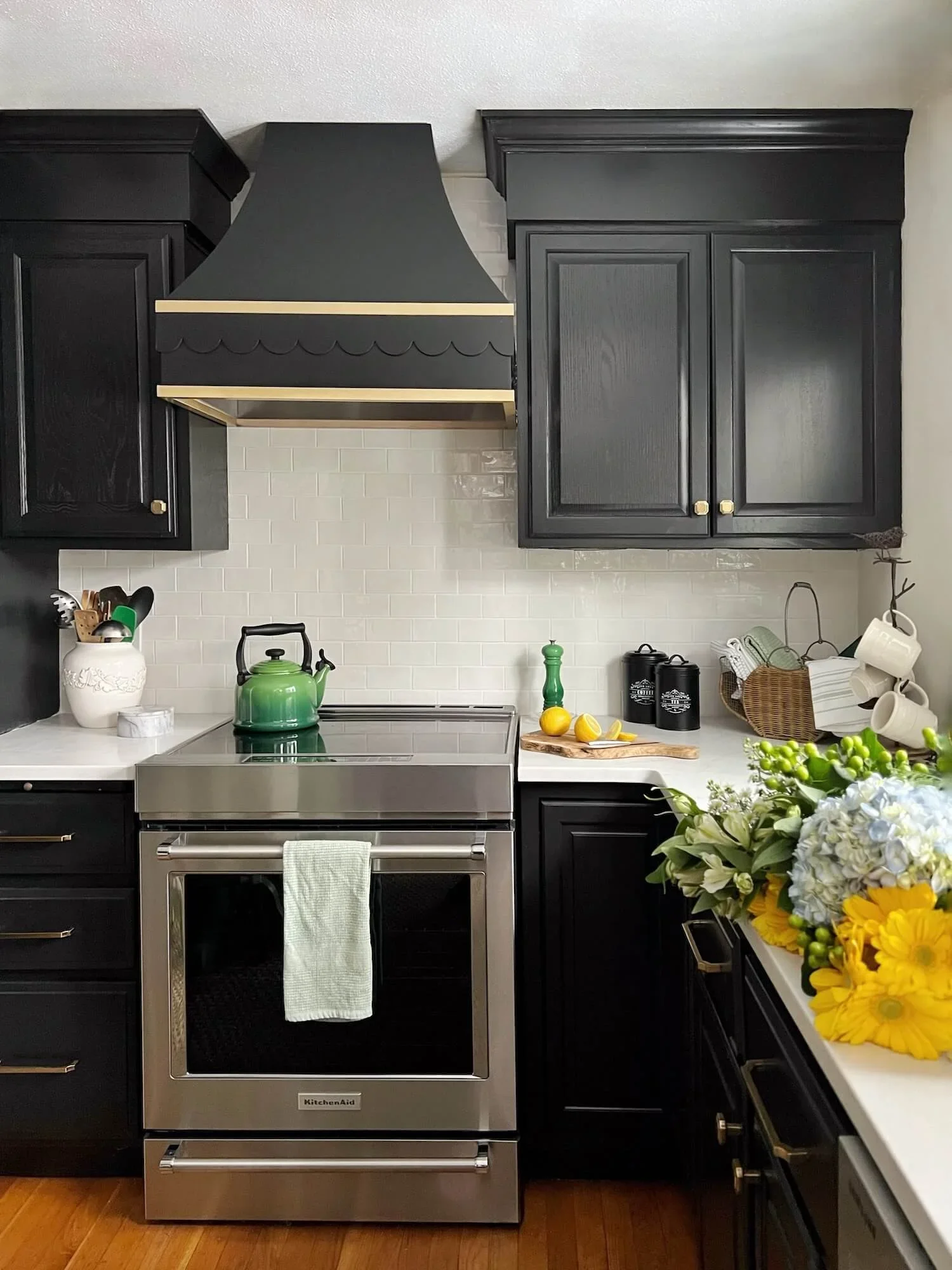 black kitchen cabinets with white and gold accents