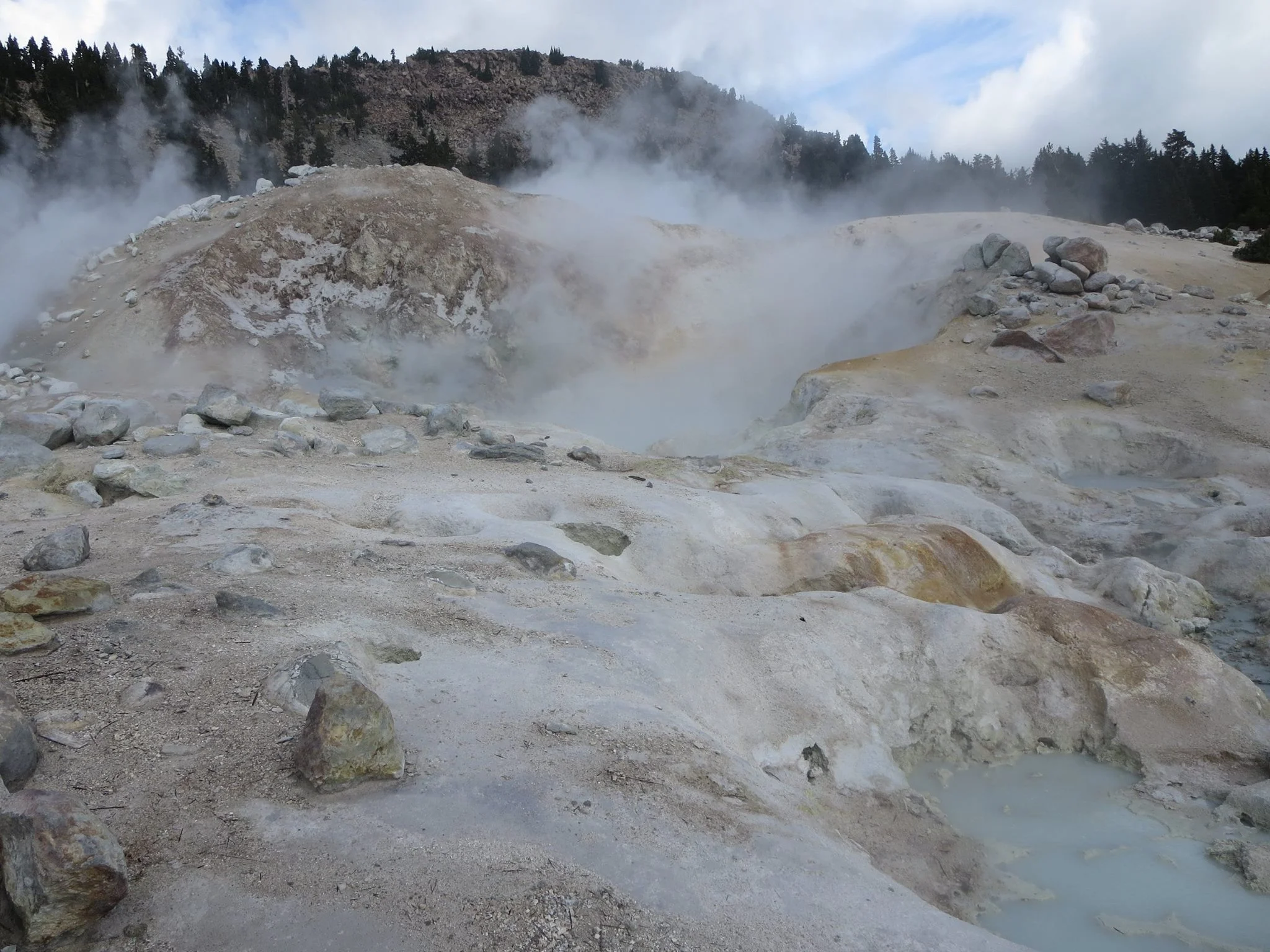 Bumpass Hell is a moderate, 3-mile trail that leads you to the park’s largest hydrothermal area. The hike features nice views and ends at a large area with steaming pools, bubbling mud pots, boiling pools, and sulfur streams—features you could see, hear… and smell. NOTE: Bumpass Hell is closed for a restoration project until at least the end of the 2018. Aw, hell… 