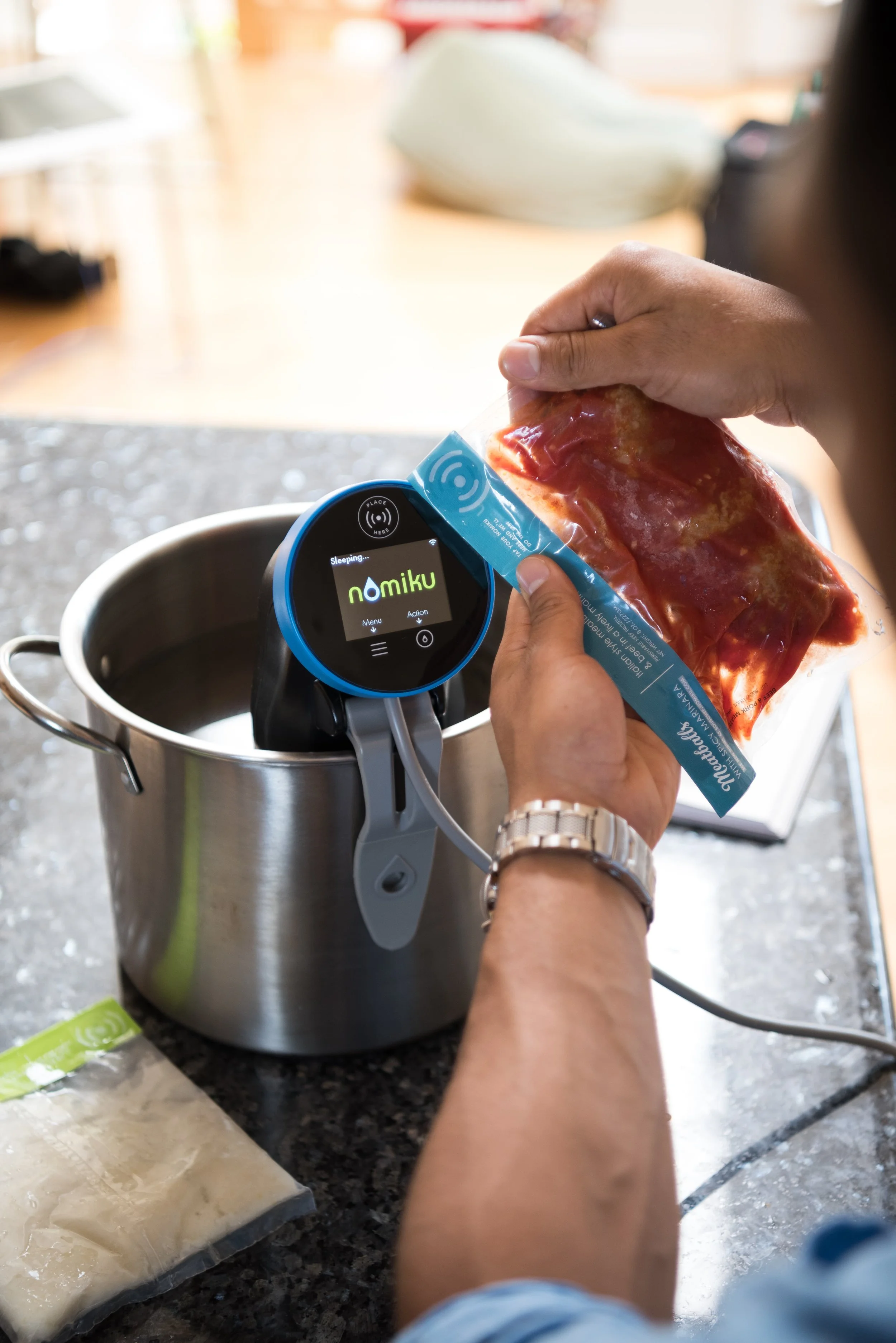 Nomiku Nomiku is a San Francisco-based company making a sous-vide immersion circulators designed for the home cook. Sous vide is the method of cooking vacuum-sealed food in a precise low-temperature water bath. Simply immerse your ingredients, then walk away. Meat and vegetables become perfectly prepared and flavorful. Perfect for busy families, Nomiku now delivers chef-prepared meals to homes across California. This delivery food service easily caters to varying dietary needs with modular dishes that are designed to mix and match. Nom-ready meals in 30 minutes or less. No prep, no clean up, just good food when you want it. Nomiku Sous Chef Meals is the meal kit that cooks itself in 30 minutes!