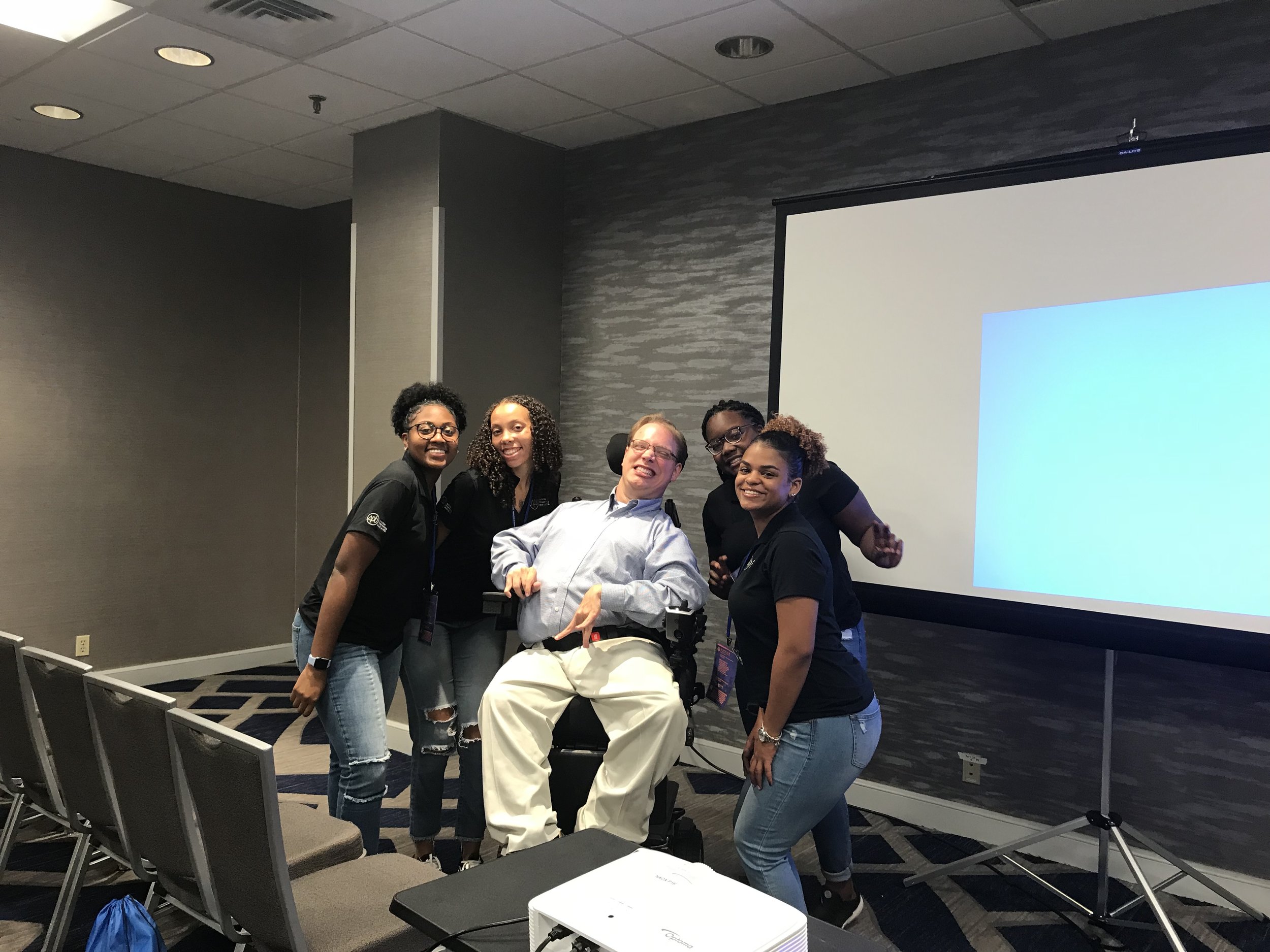 PHOTO: Matthew smiling with four enthusiastic students from VCU's Student activities board. This was after his presentation at the NACA South conference in Atlanta, Georgia.