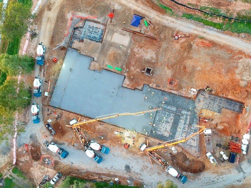 Week 6 ...First pour of ground floor Post Tensioned slab completed with a little concrete pump boom dance.
Pic by Bryant Construction drone dood 
#newmancatholiccollegejcu