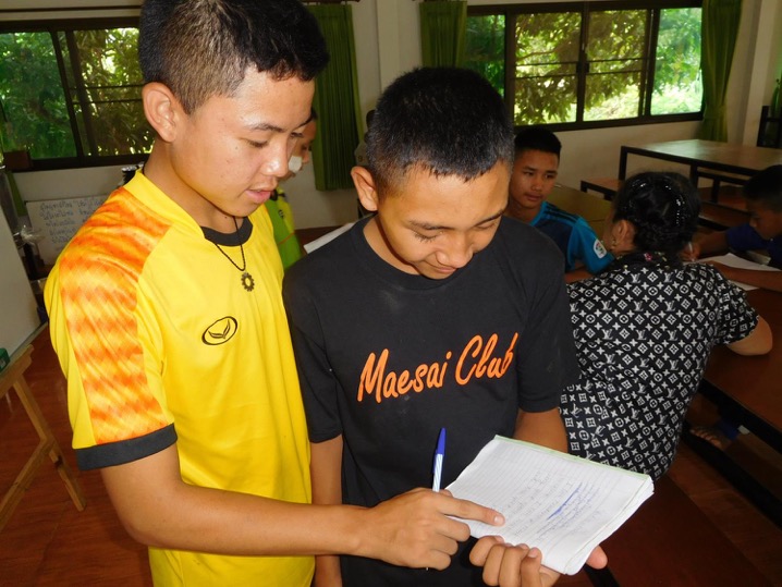 Helping each other write letters to sponsors