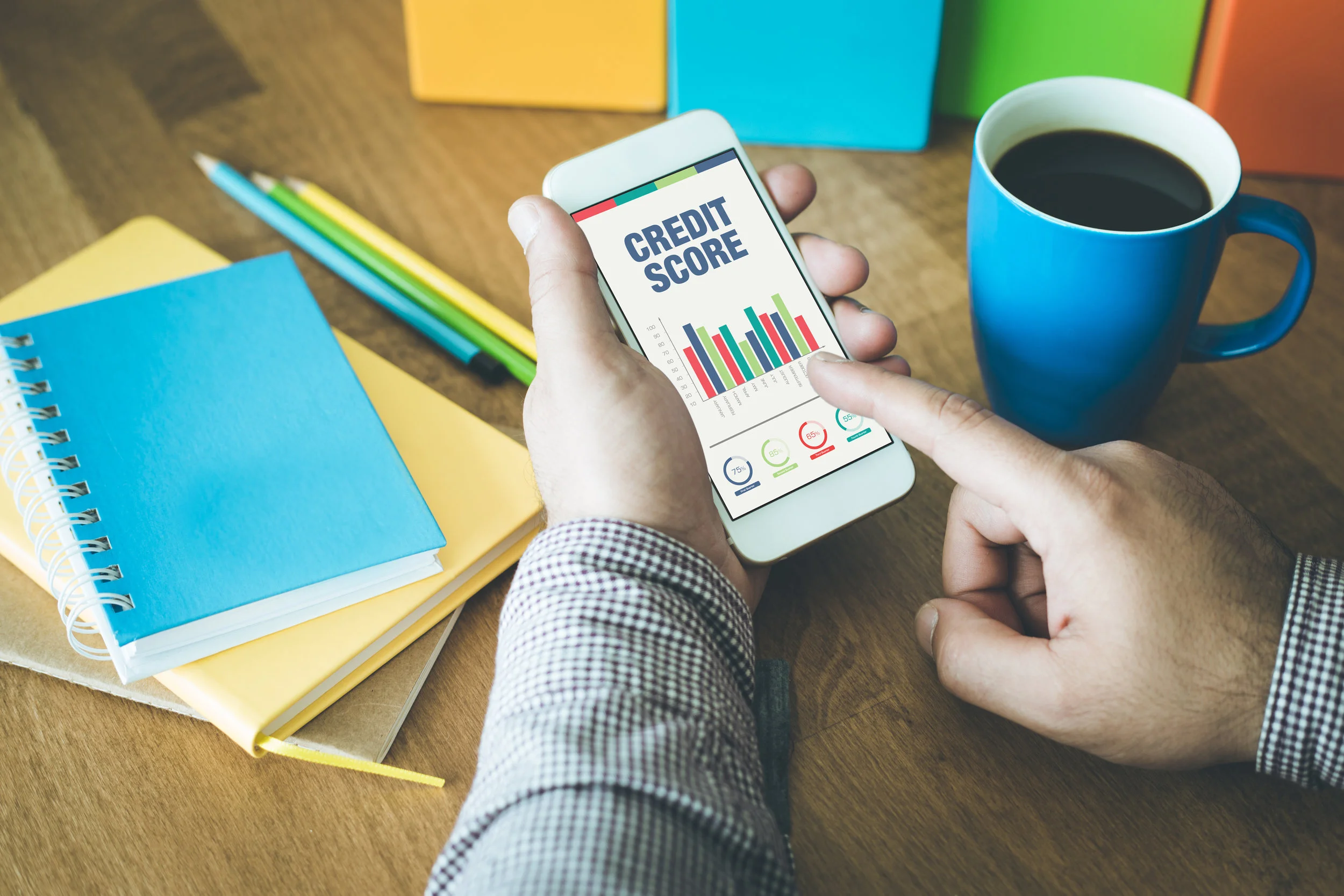 Person Checking Credit Score on a cell phone to budget for a new home