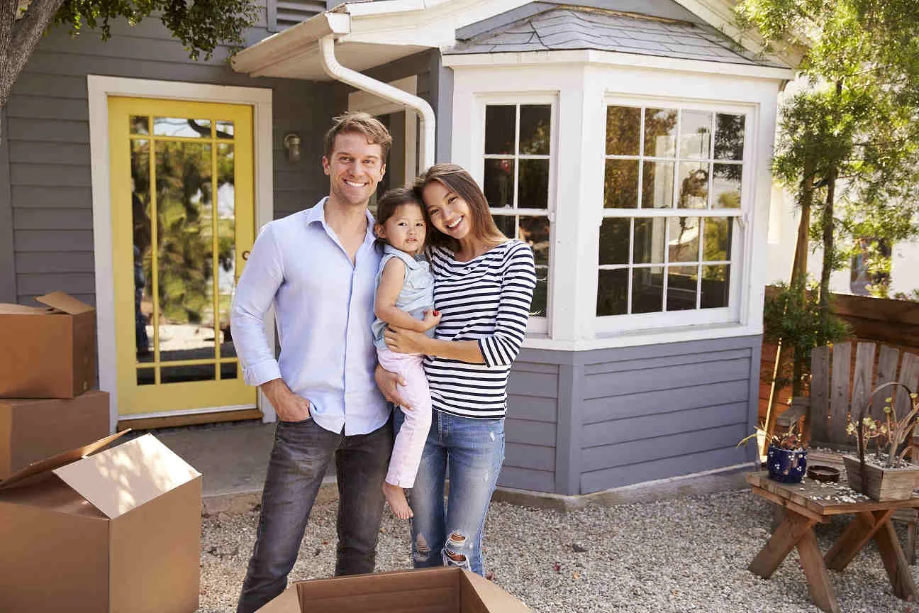 Family in front of home bought with a PACE Loan