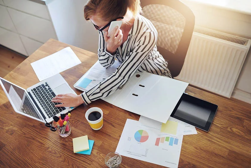 business-woman-desk-phone-computer-coffee.jpg