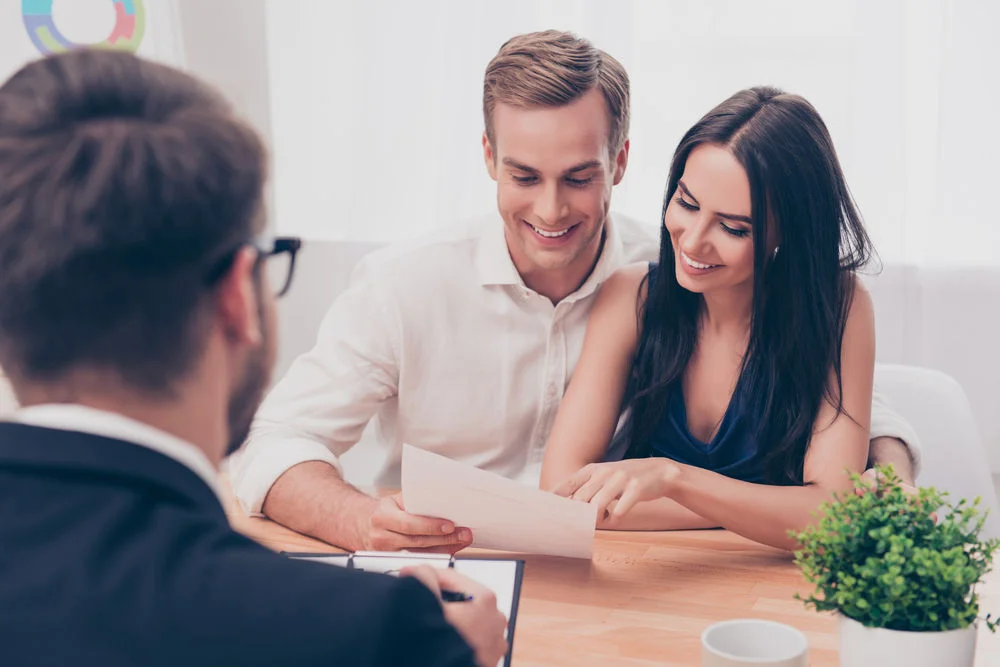 young couple looking at papers with service provider.jpg