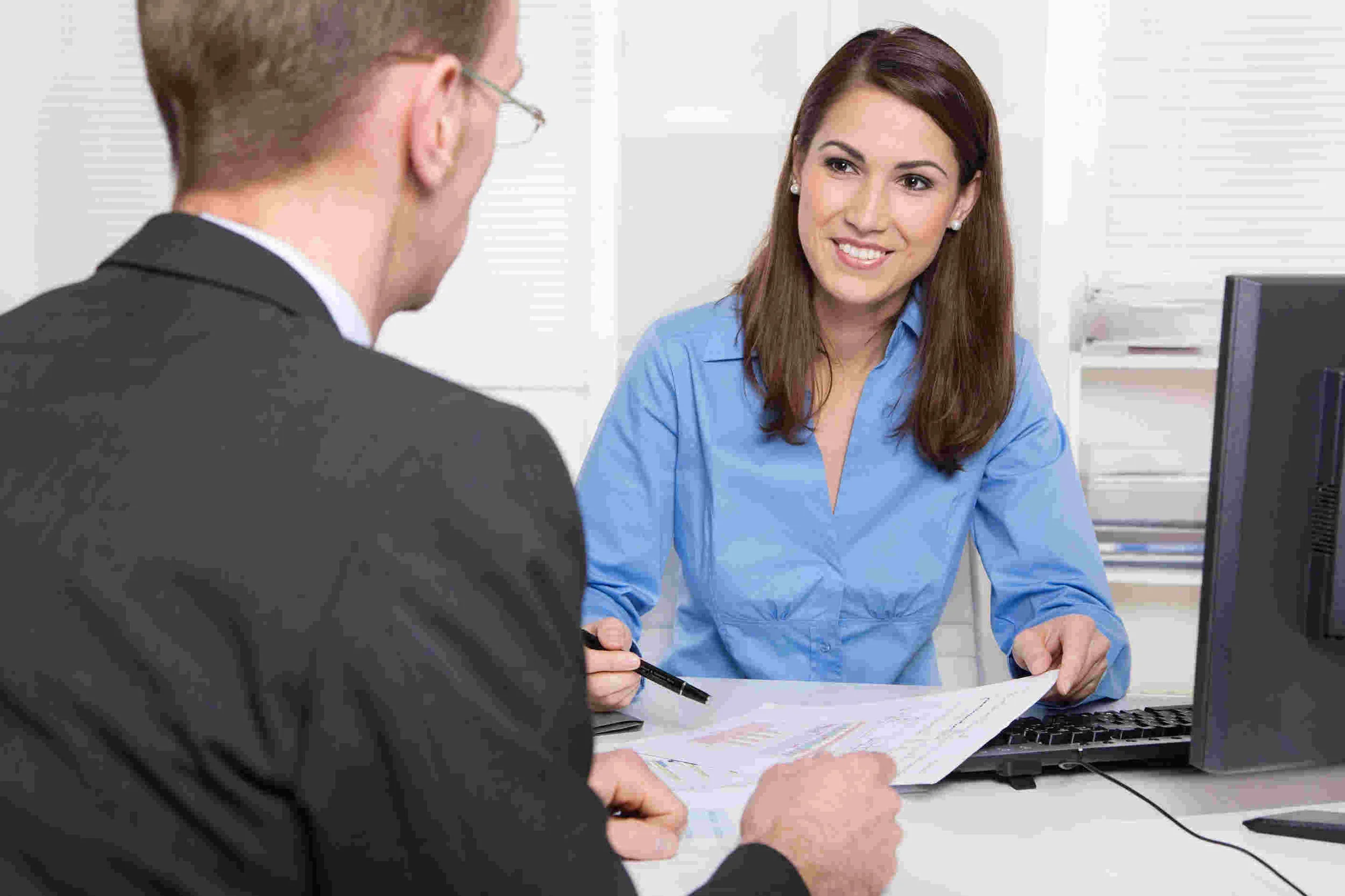 woman-and-man-discussing-paperwork-at-desk.jpg