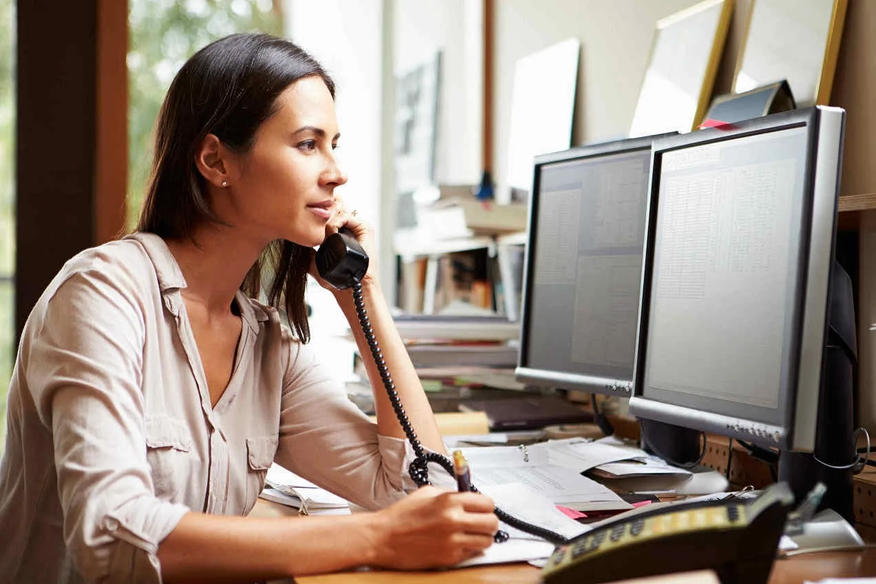 young-business-woman-on-phone-and-computer.jpg