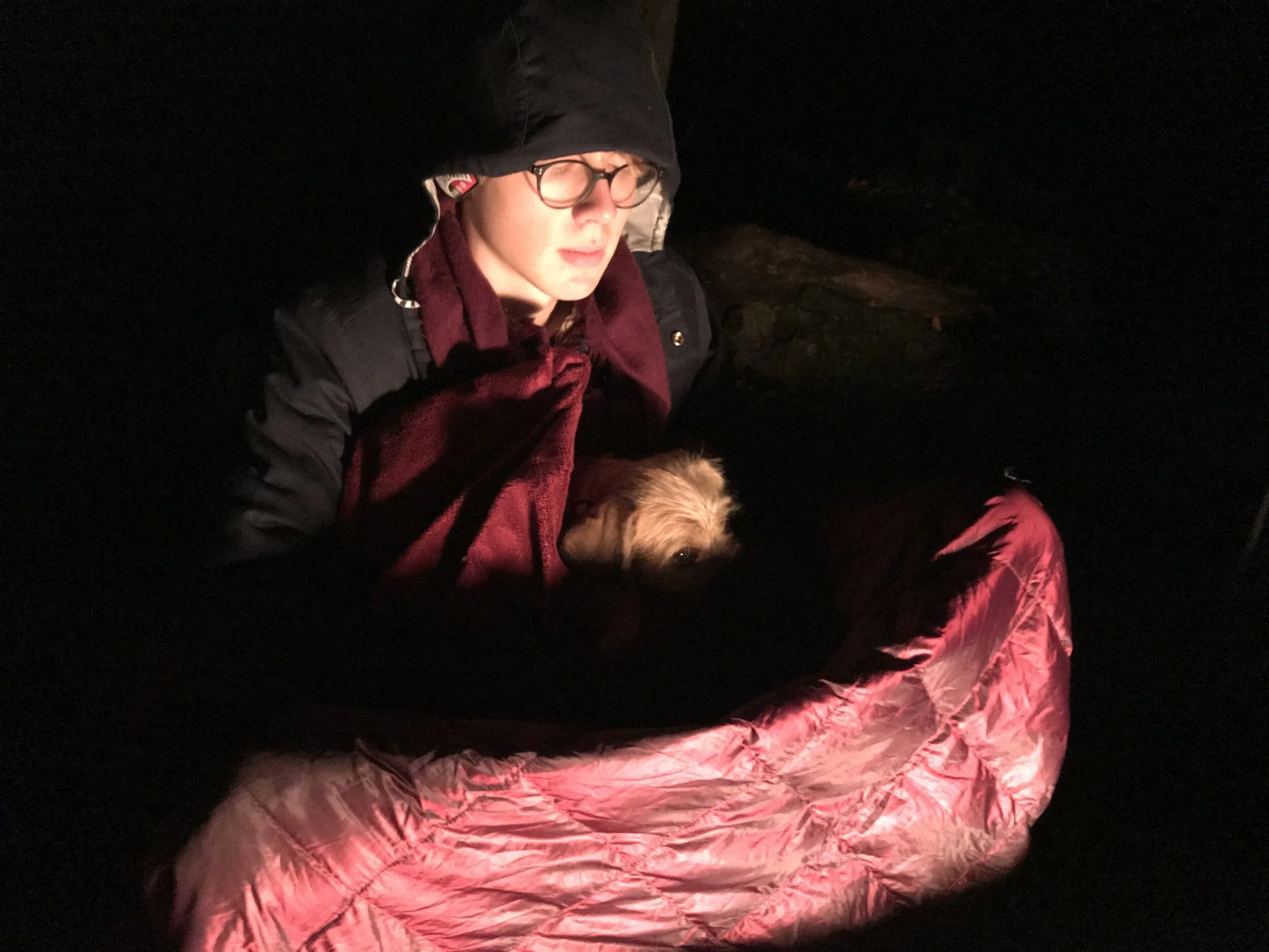 Our Aidan warming up by a fire with the pup Bindi, on a cold night on our dirt, the Nameless Canyon Grove, last Christmas.
