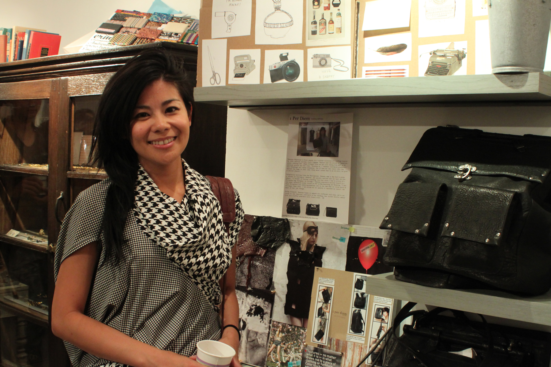 Above is Vanessa Espinosa, of 1 per diem , standing near her board and luxe leather bags.