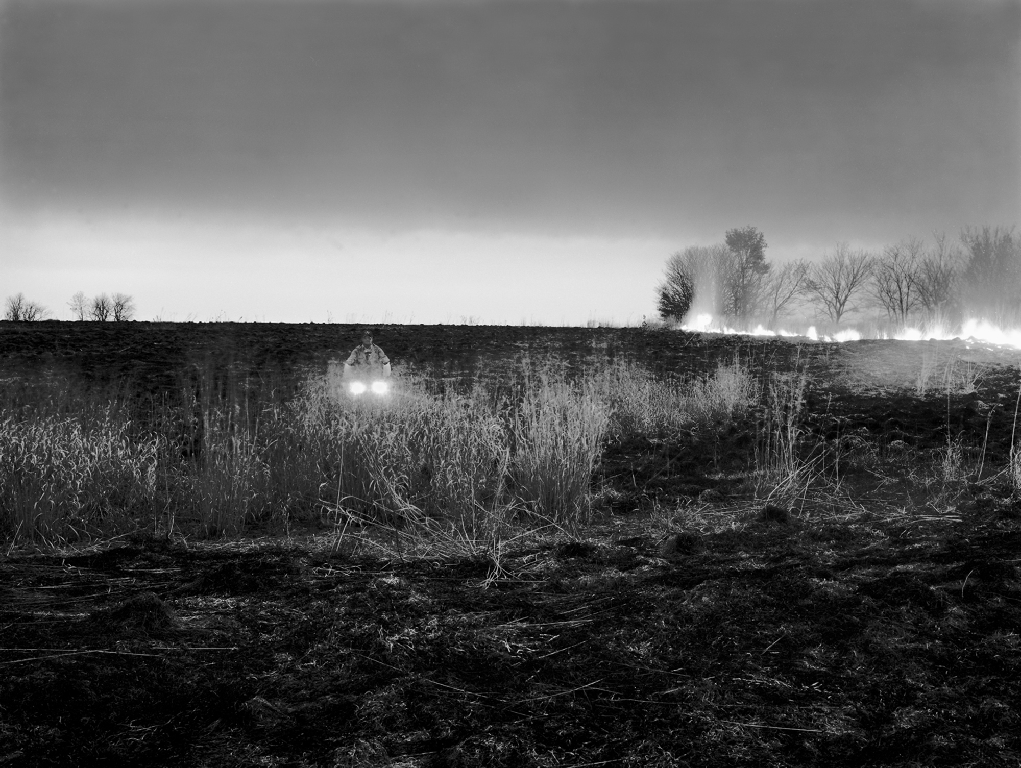 A rancher burning a field - Osage, KS.